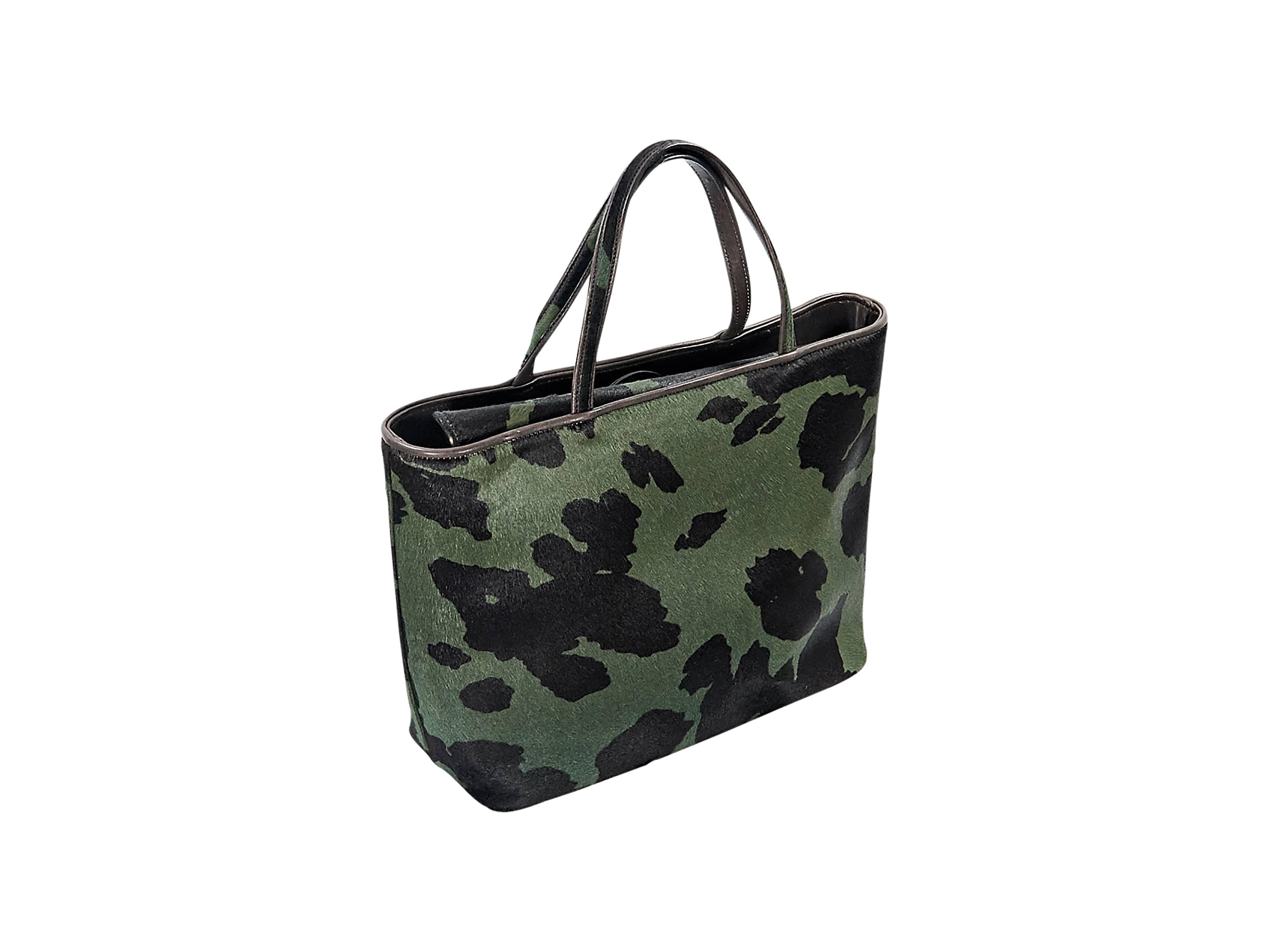 Product details:  Green and black printed pony hair tote bag by Jimmy Choo.  Dual carry handles.  Magnetic snap closure.  Lined interior with inner zip pocket.  Protective metal feet.  Silvertone hardware.  14
