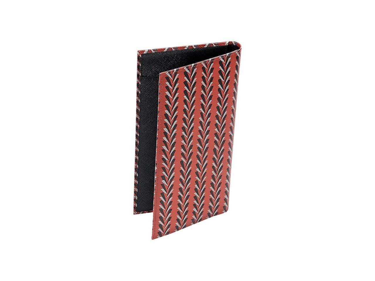 Product details:  Red printed saffiano leather cardholder wallet by Prada.  Lined interior with multiple credit card slots.  4.5