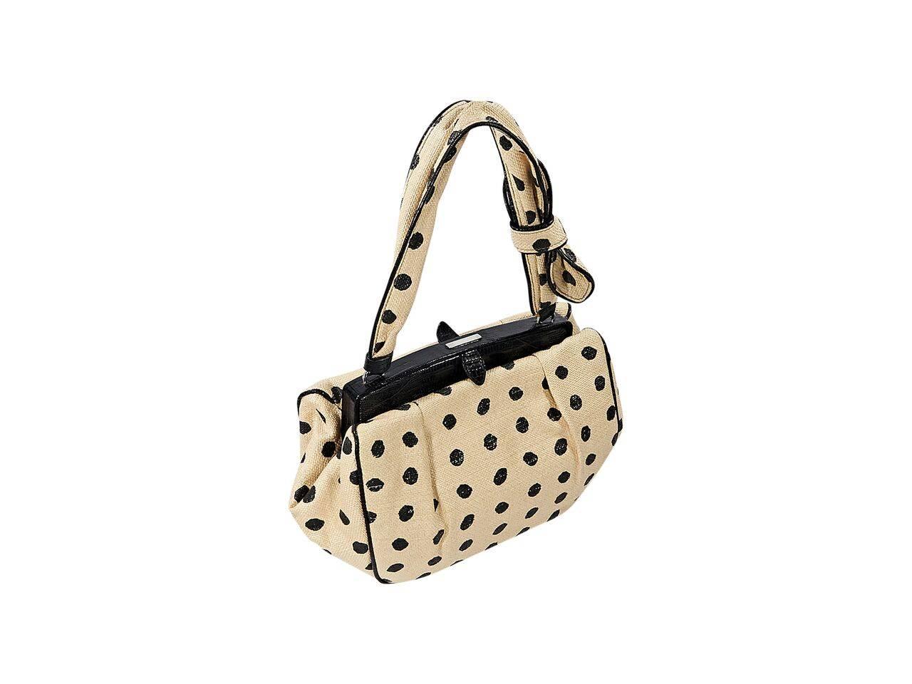 Product details:  Tan and black polka-dot raffia shoulder bag by Alaia.  Trimmed with black lizard.  Single shoulder strap.  Top push-lock closure.  Lined interior with inner flap pocket.  Silvertone hardware.  12"L x 7"H x 4"D. 