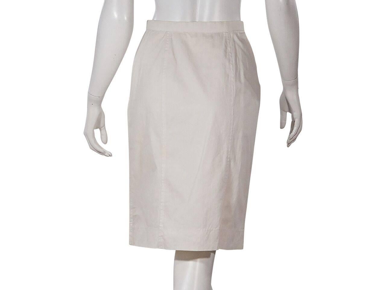 Product details:  Vintage white pencil skirt by Chanel.  Banded waist.  Double button front.  Front slide pockets.  Goldtone hardware. 
Condition: Pre-owned. Very good.
Est. Retail $ 1,000.00