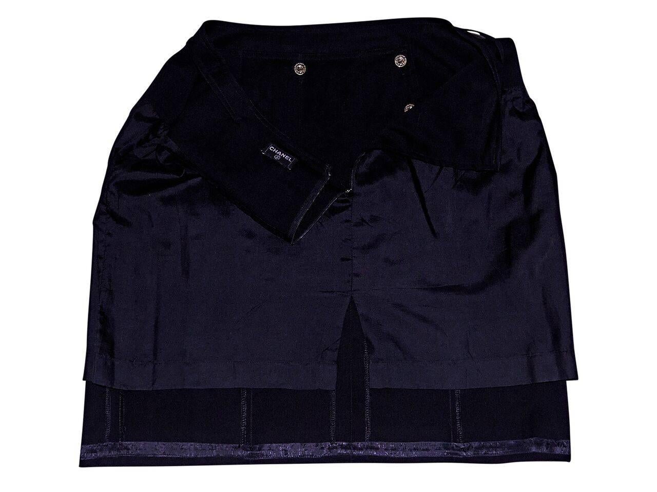 Product details:  Vintage black pleated sailor skirt by Chanel.  Button-front details.  Concealed back zip closure.  Goldtone hardware.  
Condition: Pre-owned. Very good.
Est. Retail $ 1,198.00