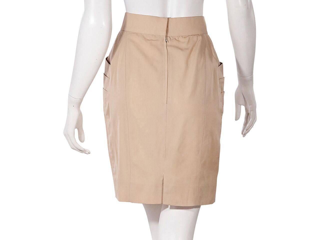 Product details:  Vintage tan pleated skirt by Chanel.  Banded waist.  Side slide pockets.  Concealed back zip closure.  Back center hem vent.  Label size FR 38. 
Condition: Pre-owned. Very good.
Est. Retail $ 1,298.00