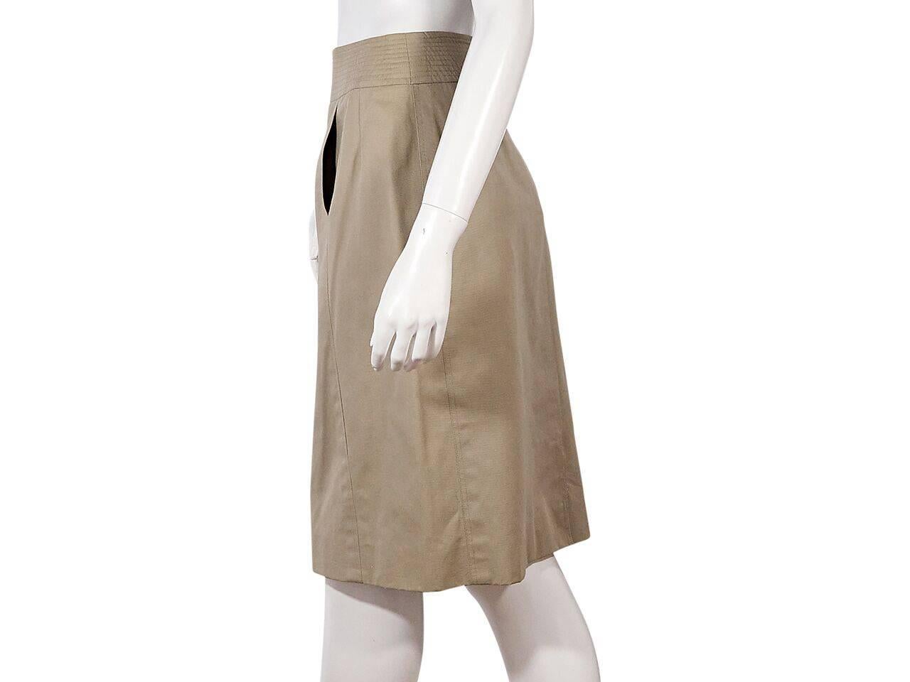 Product details:  Vintage tan pencil skirt by Chanel.  Banded waist.  Front slide pockets.  Concealed back zip closure.  Back center hem vent.  Label size FR 40.
Condition: Pre-owned. Very good.
Est. Retail $ 950.00