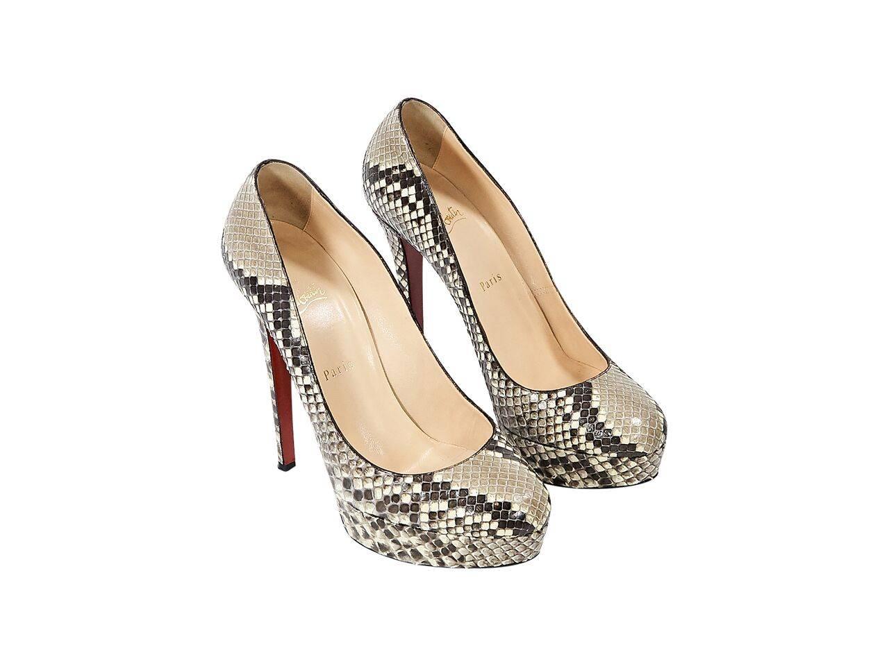Product details:  Tan python Bianca pumps by Christian Louboutin.  Round toe.  Towering stiletto heel and platform design.  Iconic red sole.  Slip-on style. 
Condition: Pre-owned. Very good.  
Est. Retail $ 1,500.00