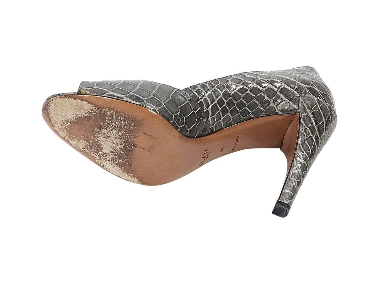 Product details:  Grey crocodile pumps by Alaia.  Peep toe.  Slip-on style. 
Condition: Pre-owned. Very good.  
Est. Retail $1,500.00