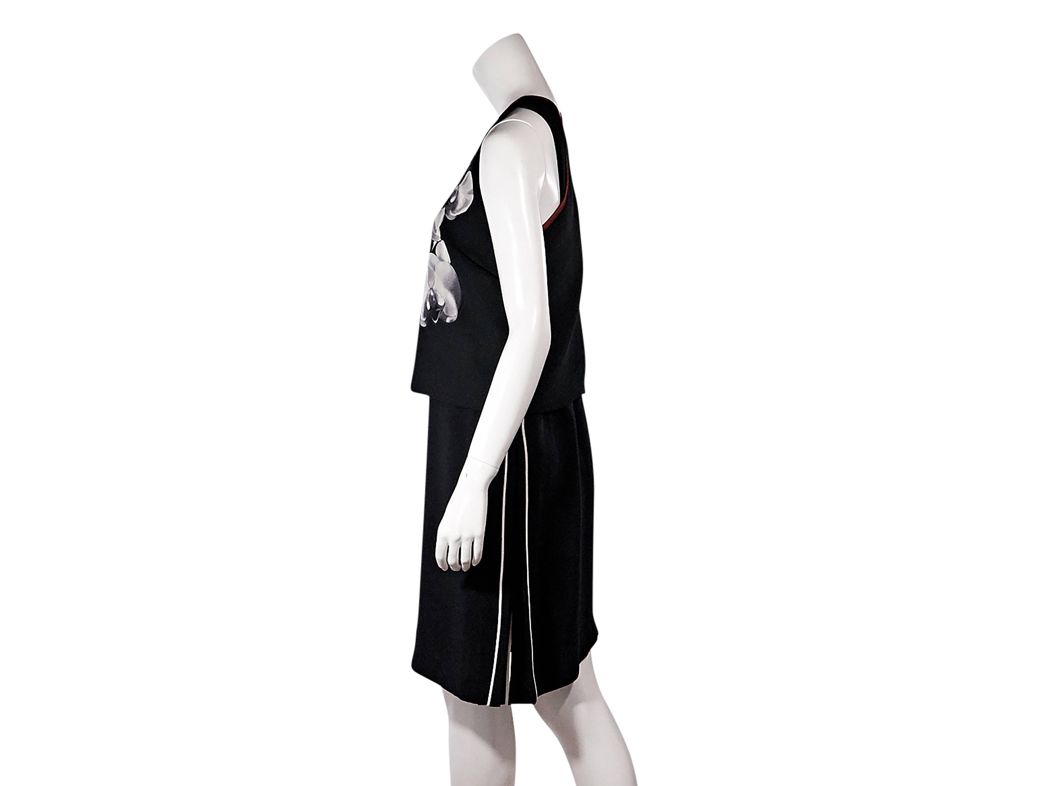 Product details:  Black floral-printed dress by Fendi.  Scoopneck.  Sleeveless.  Front overlay.  Crisscross back.  Size 8
Condition: Pre-owned. Very good.

Est. Retail $ 1,498.00