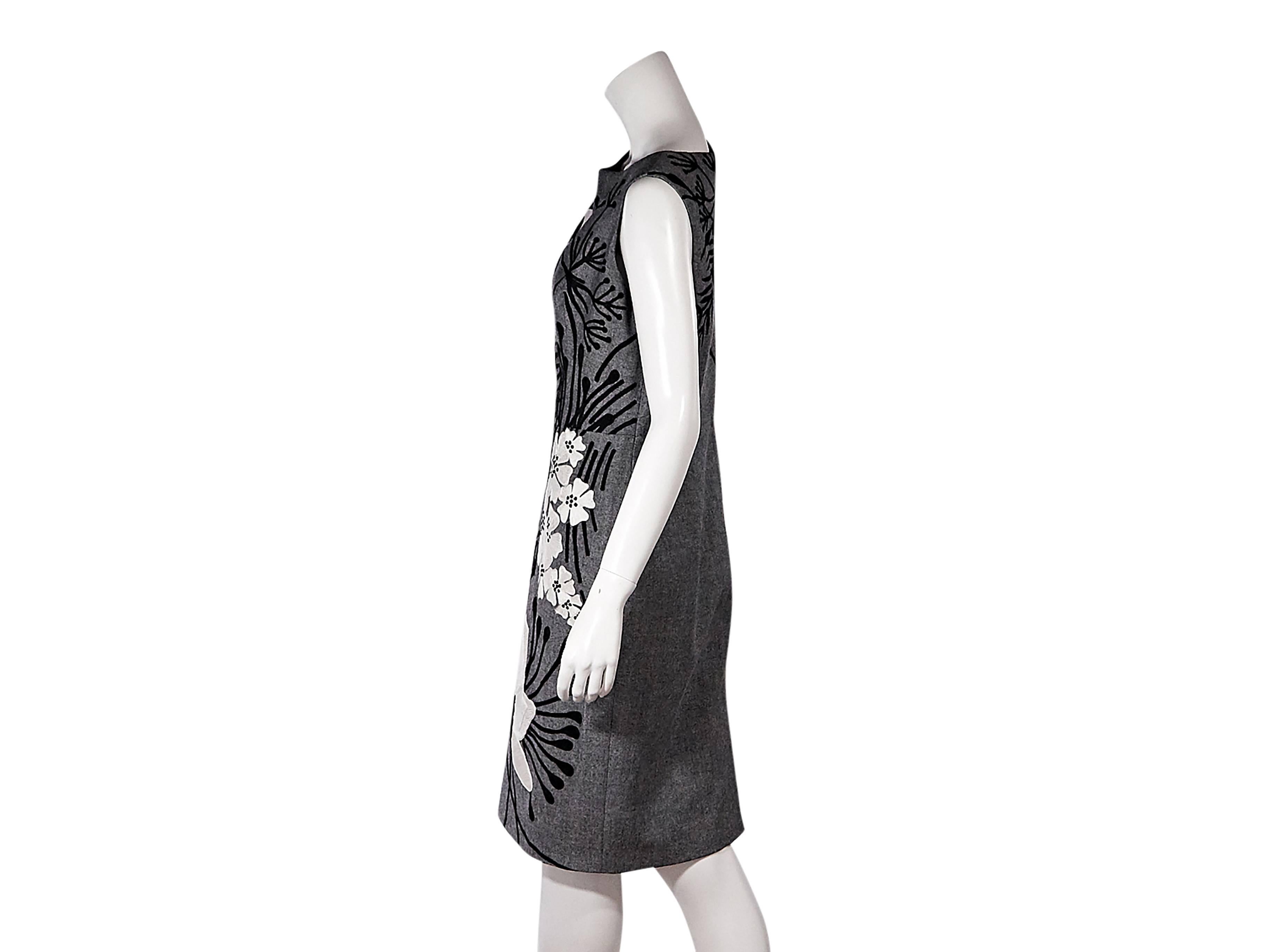 Product details:  Grey sheath dress by Carolina Herrera.  Features black and white floral embroidery.  Boatneck.  Sleeveless.  Concealed back zip closure.  Back center hem vent.  Size 12
Condition: Pre-owned. Very good.

Est. Retail $ 1,198.00