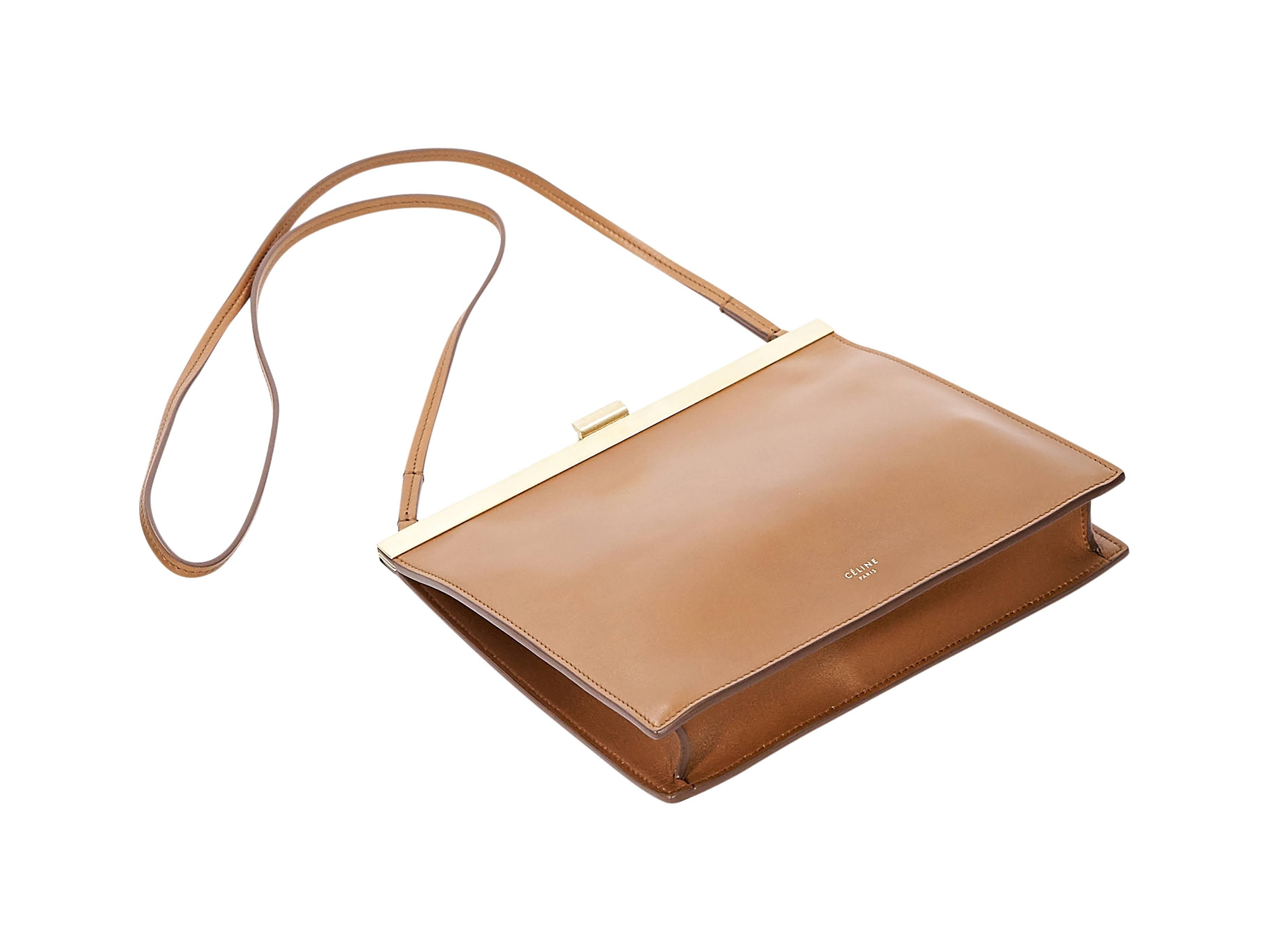 Product details:  Tan smooth calfskin mini clasp bag by Céline.  From the FW17 collection.  Thin shoulder strap.  Top push-lock clasp closure.  Leather lined interior with inner credit card slots.  Goldtone hardware.  Includes original cards and