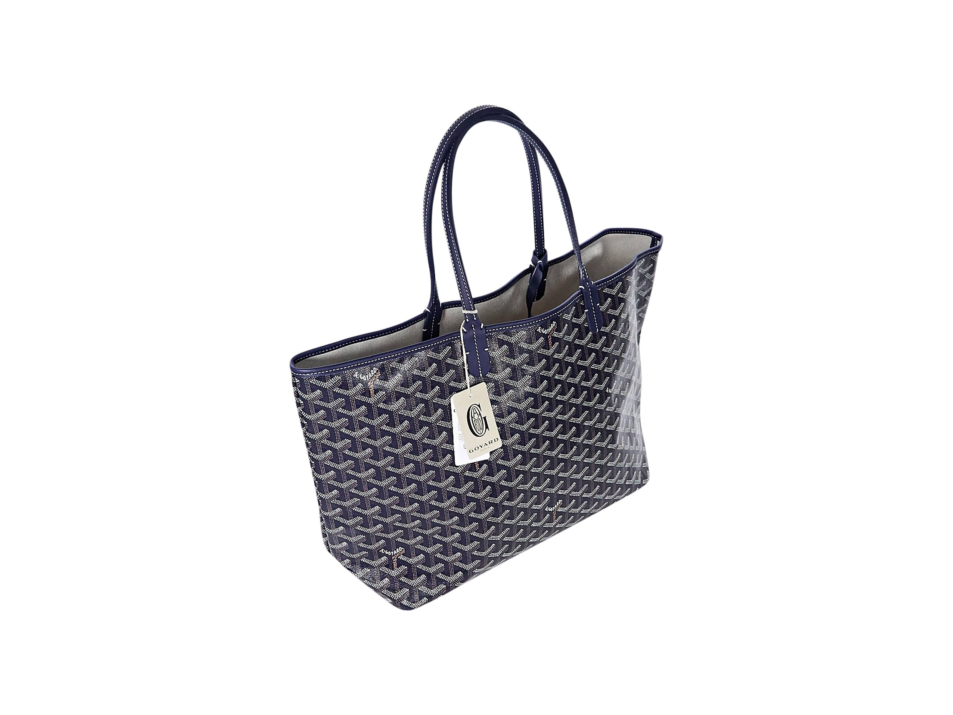 Product details:  Navy blue St. Louis tote bag by Goyard.  Trimmed with leather.  Dual carry handles.  Open top.  Lined interior.  Matching inner pouch.  Includes original cards and dustbag. 10