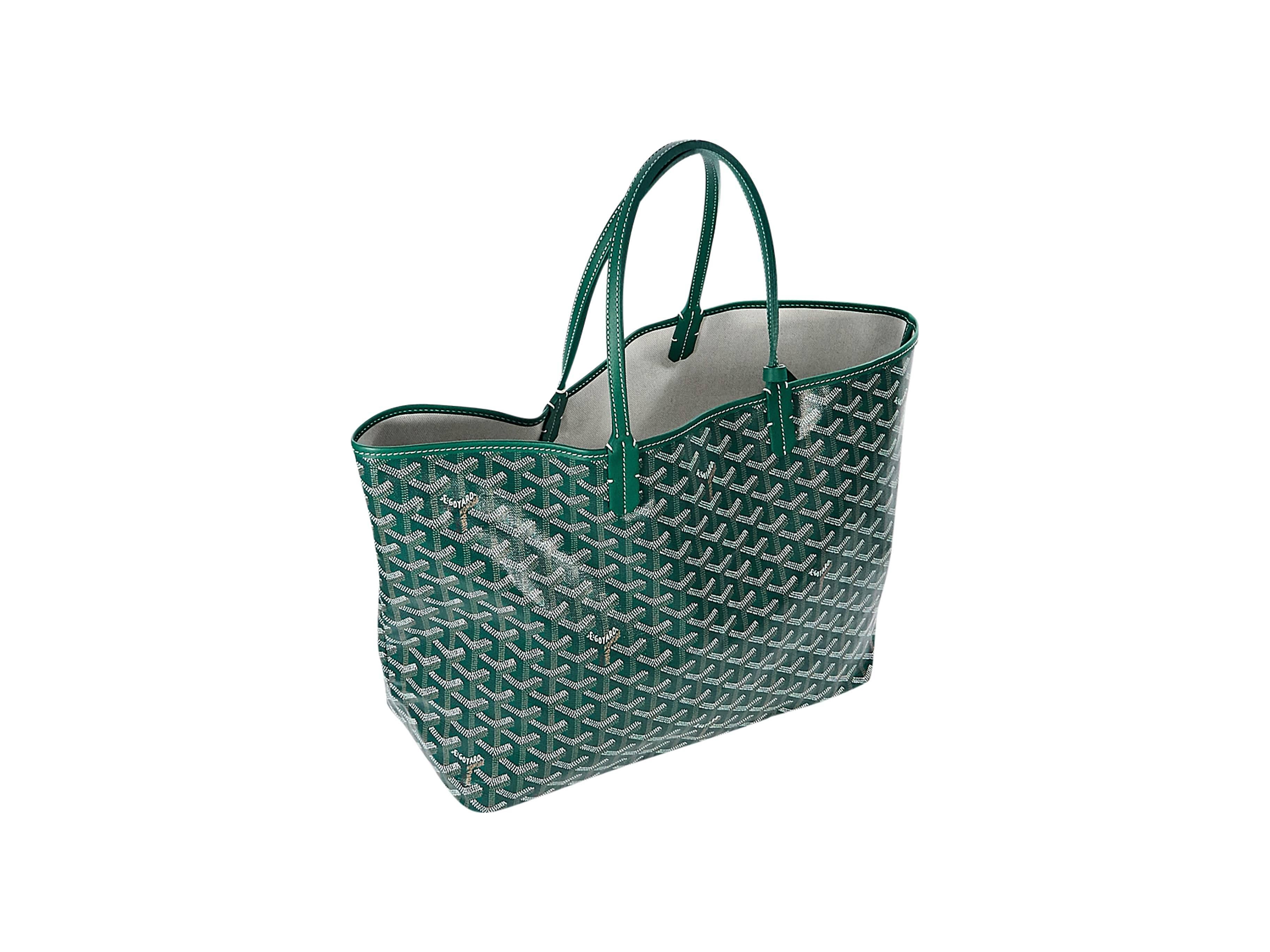 Product details:  Green St. Louis tote bag by Goyard.  Dual shoulder straps.  Open top.  Inner attached matching pouch.  Silvertone hardware.  10