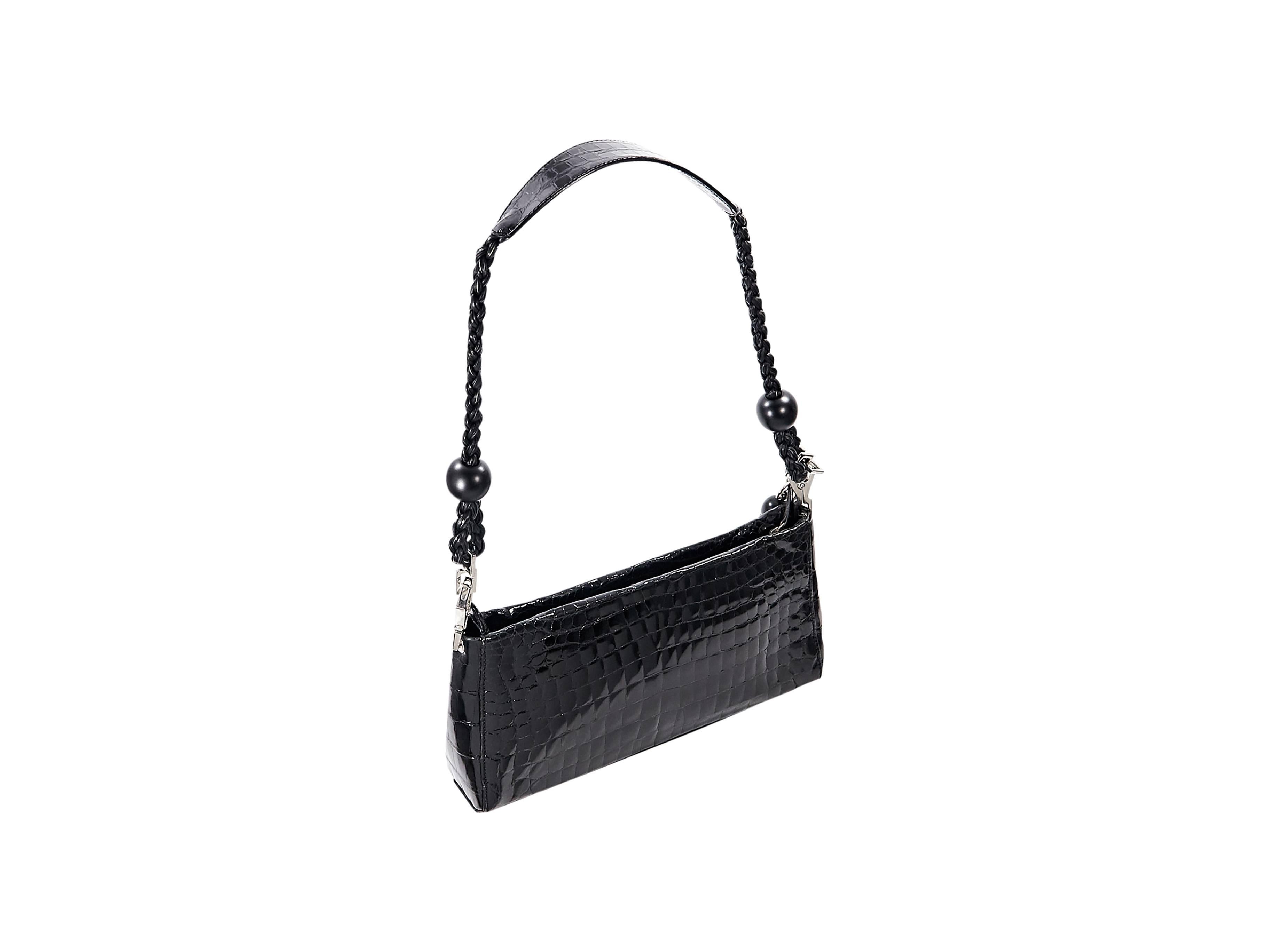 Product details:  Small black crocodile shoulder bag by Suarez.  Detachable braided shoulder strap.  Top zip closure with tassel pull.  Lined interior with inner zip pocket.  Silvertone hardware.  12.5