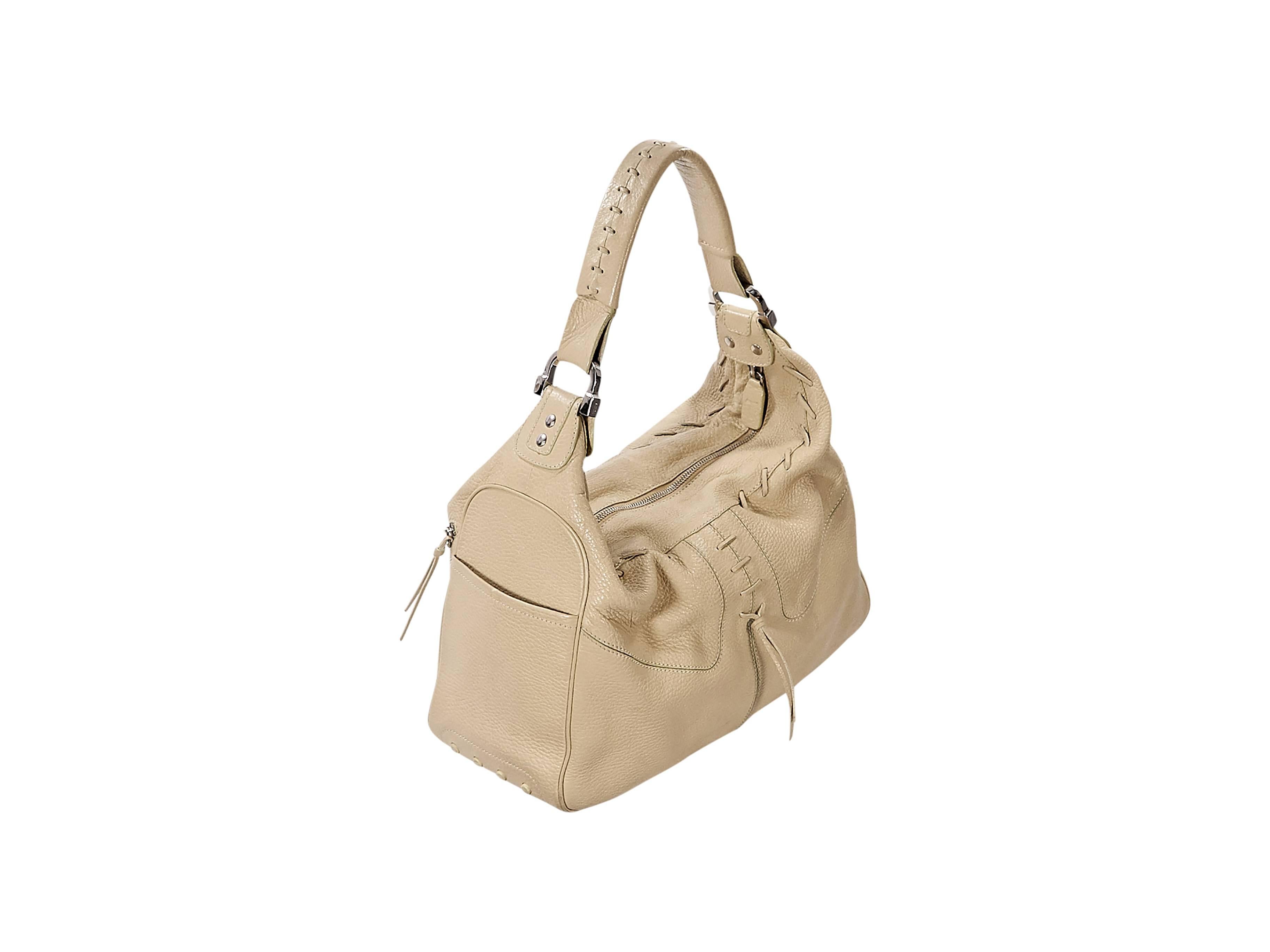 Product details:  Nude leather Milky shoulder bag by Tod's.  Accented with whipstitched trim.  Single shoulder strap.  Front exterior zip pockets.  Top zip closure.  Lined interior with inner zip pocket.  Side exterior slide pockets.  Silvertone