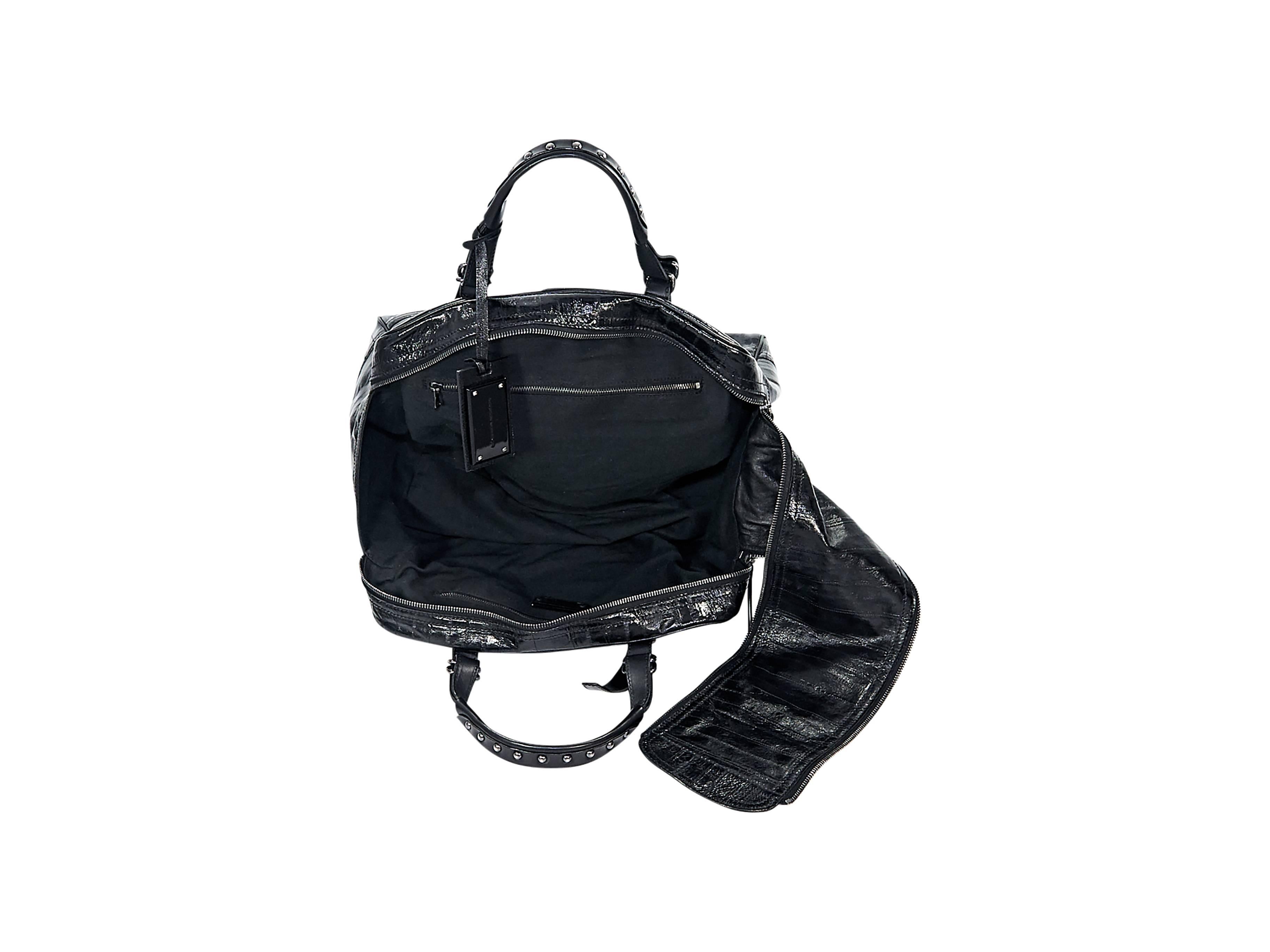 Product details:  Black patent leather handbag by Sigerson Morrison.  Studded dual carry handles.  Removable logo tag.  Double top zip closure.  Lined interior with inner zip pockets.  Protective metal feet.  Silvertone hardware.  13.5