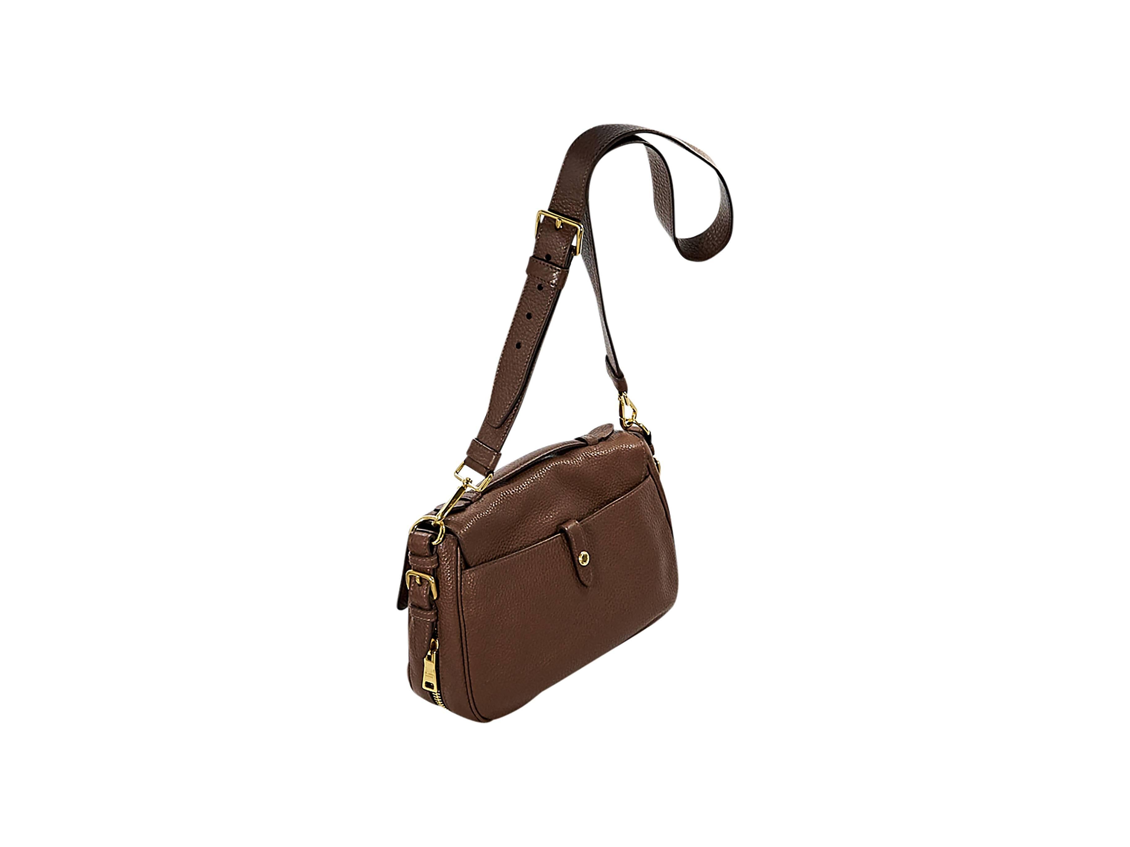 Product details:  Brown pebbled leather small messenger bag by Prada.  Top carry handle.  Detachable, adjustable crossbody strap.  Front flap over exterior slide pocket.  Push-lock and double buckle front closure.  Side zipper accents.  Lined