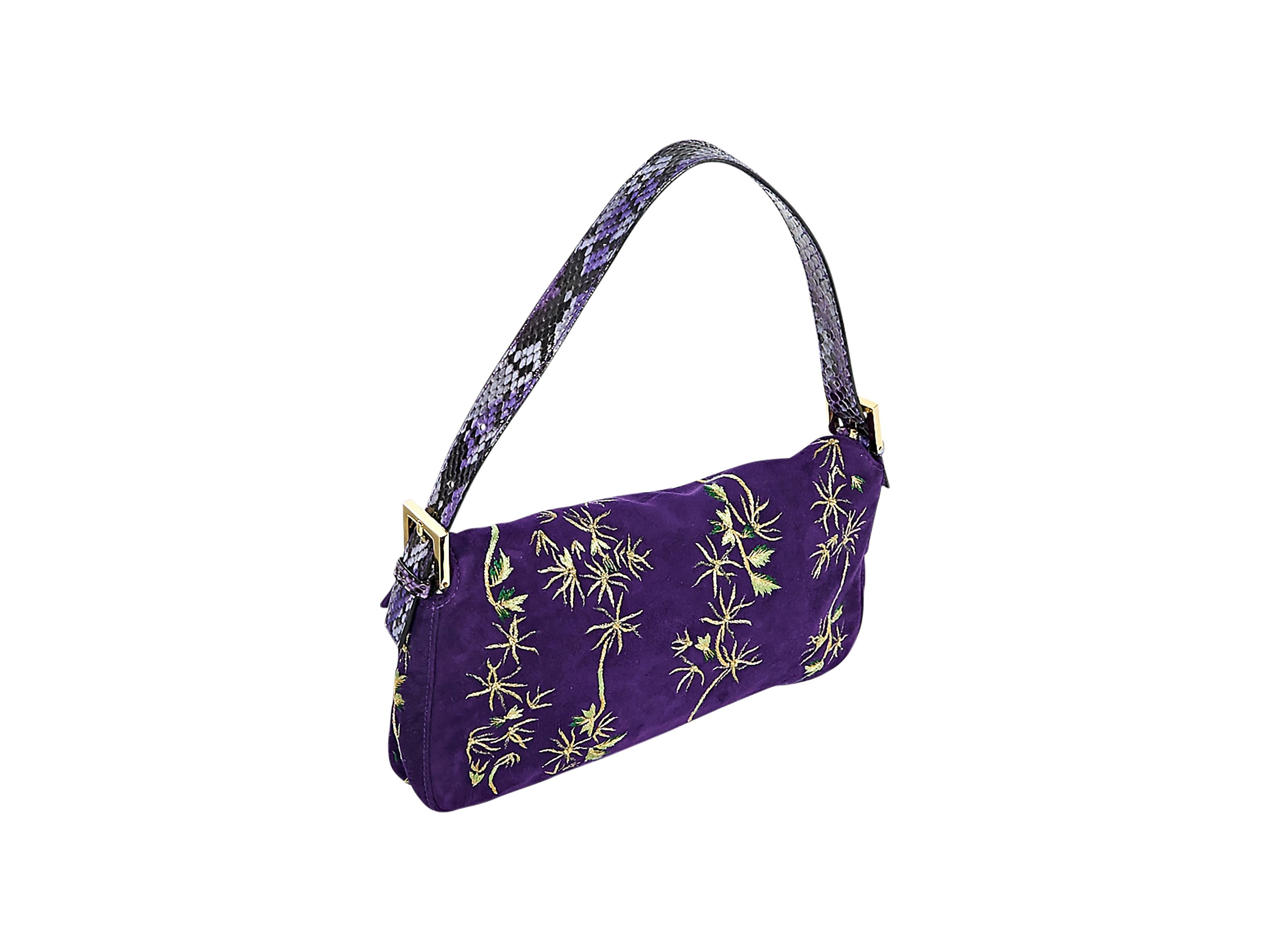 Product details:  Purple suede Baguette shoulder bag by Fendi.  Trimmed with python skin.  Accented with metallic gold embroidery.  Adjustable shoulder strap.  Front flap with logo hardware.  Concealed magnetic snap closure.  Lined interior with