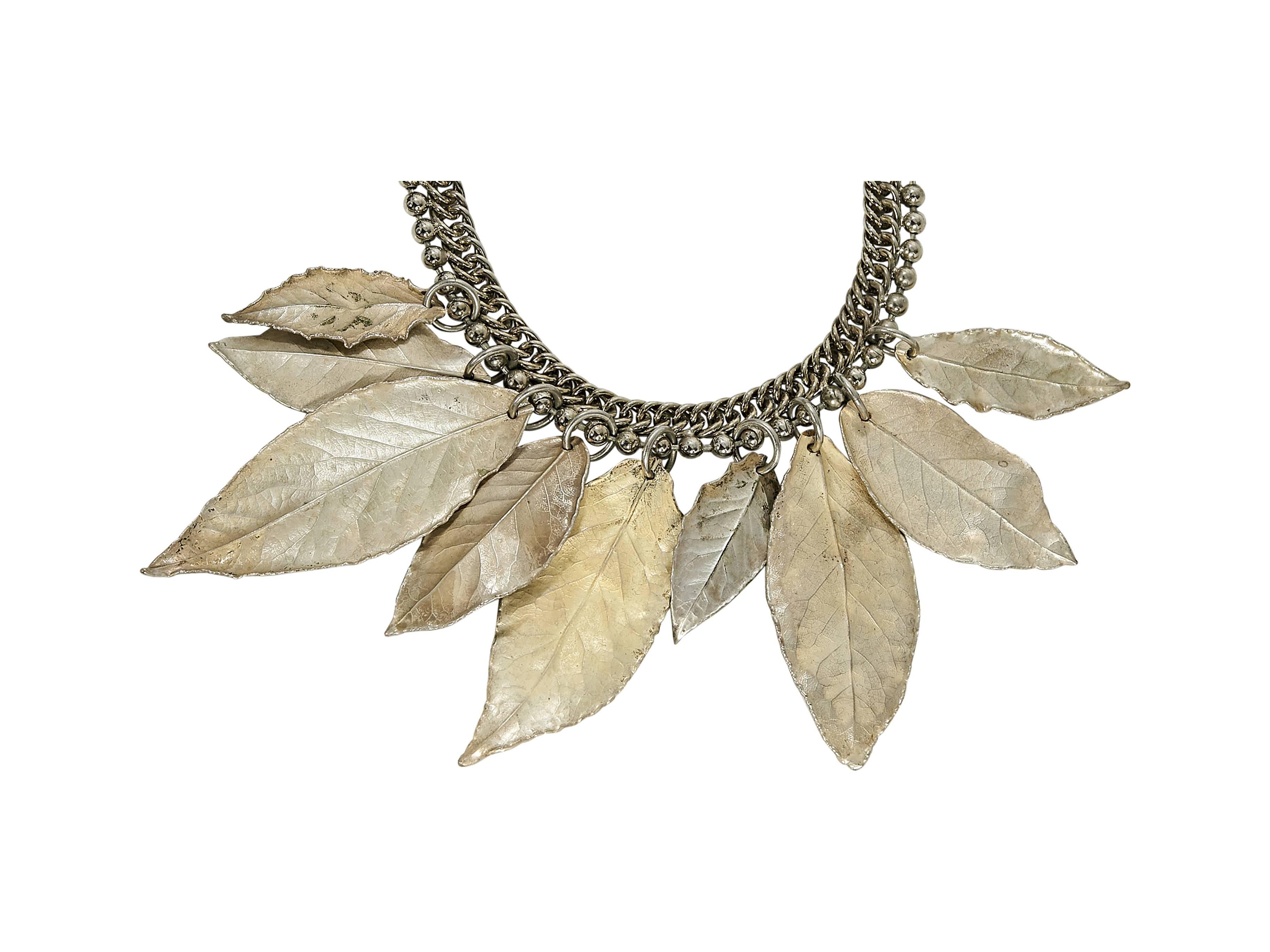Product details:  Goldtone chain collar necklace by Marni.  Accented with hanging leaf charms.  Adjustable tie closure. 
Condition: Pre-owned. Very good.

Est. Retail $ 595.00
