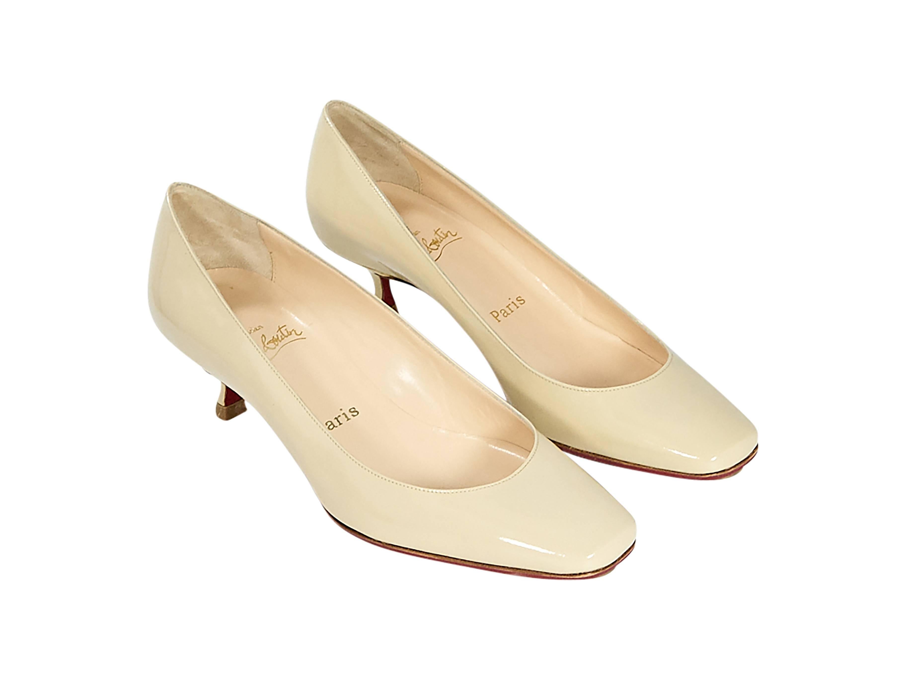 Product details:  Nude patent leather kitten heel pumps by Christian Louboutin.  Rounded square toe.  Iconic red sole.  Slip-on style. Size 8.5
Condition: Pre-owned. Very good.

Est. Retail $ 898.00
