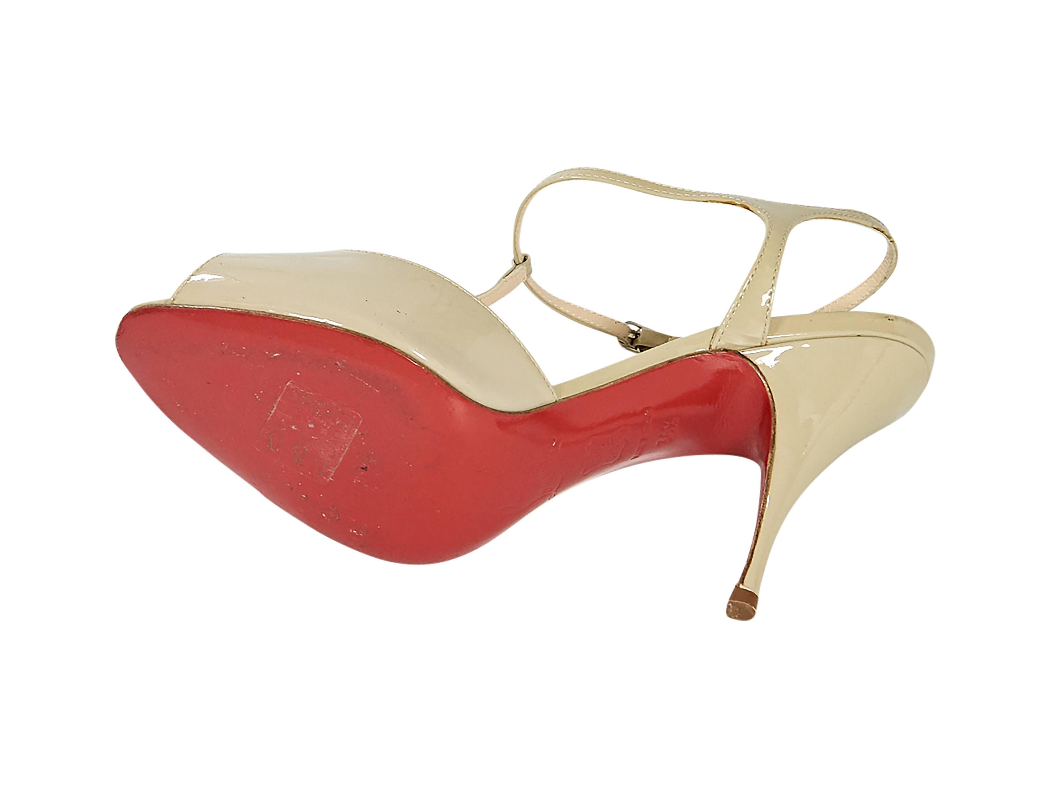 Product details:  Nude patent leather Mary Jane pumps by Christian Louboutin.  Adjustable ankle strap.  Peep toe.  Iconic red sole. Size 6.5
Condition: Pre-owned. Very good.

Est. Retail $ 998.00

