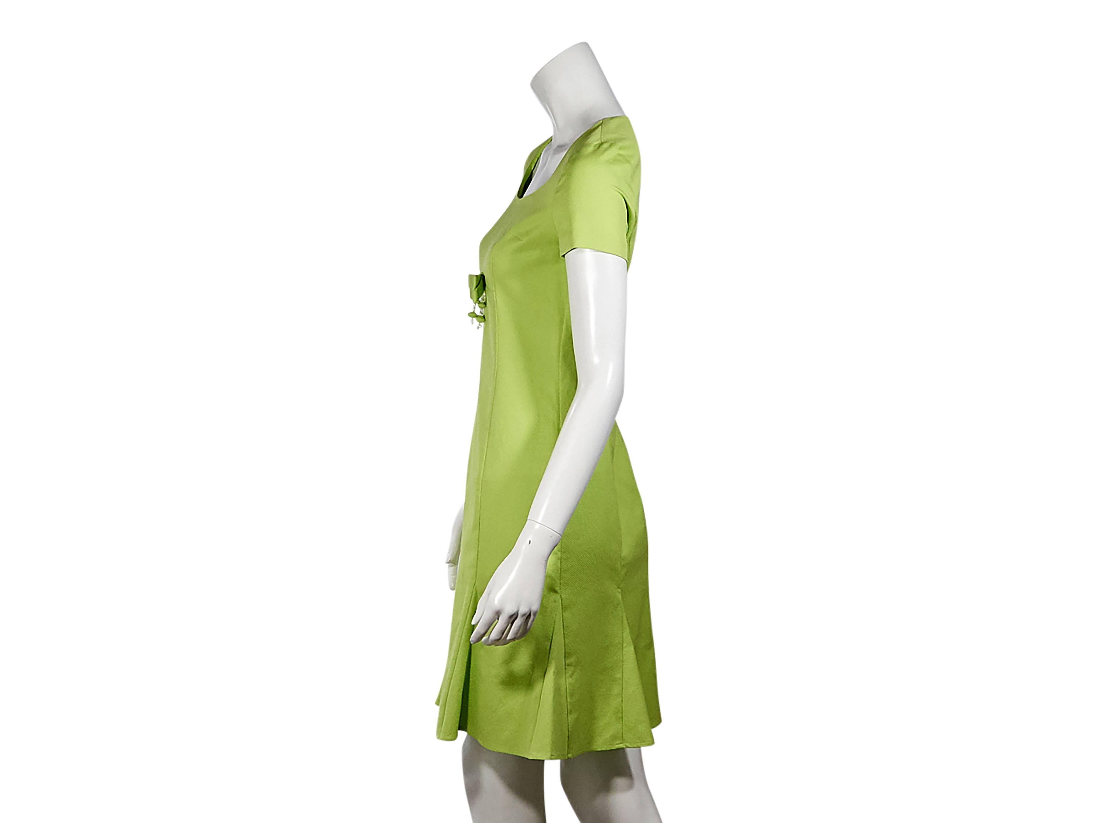 Product details:  Lime green sheath dress by Moschino Cheap + Chic.  Scoopneck.  Short sleeves.  Bow detail accents bodice.  Concealed back zip closure.  Flared pleated hem.  Size 6
Condition: Pre-owned. New with tags.

Est. Retail $ 1,200.00