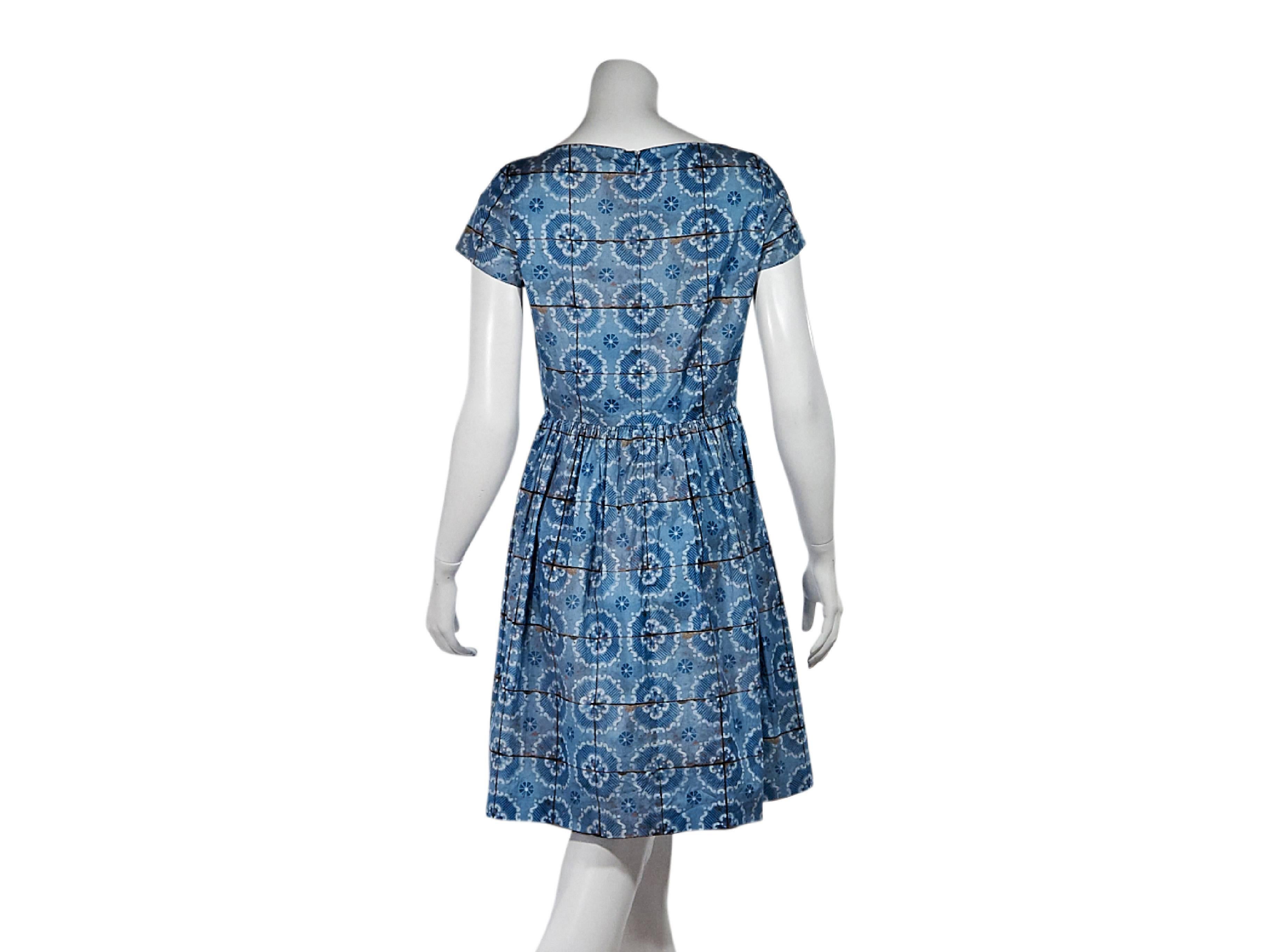Product details:  Blue floral-printed dress by Prada.  Boatneck.  Short sleeves.  Concealed back zip closure. Size 6 
Condition: Pre-owned. Very good.

Est. Retail $ 598.00
