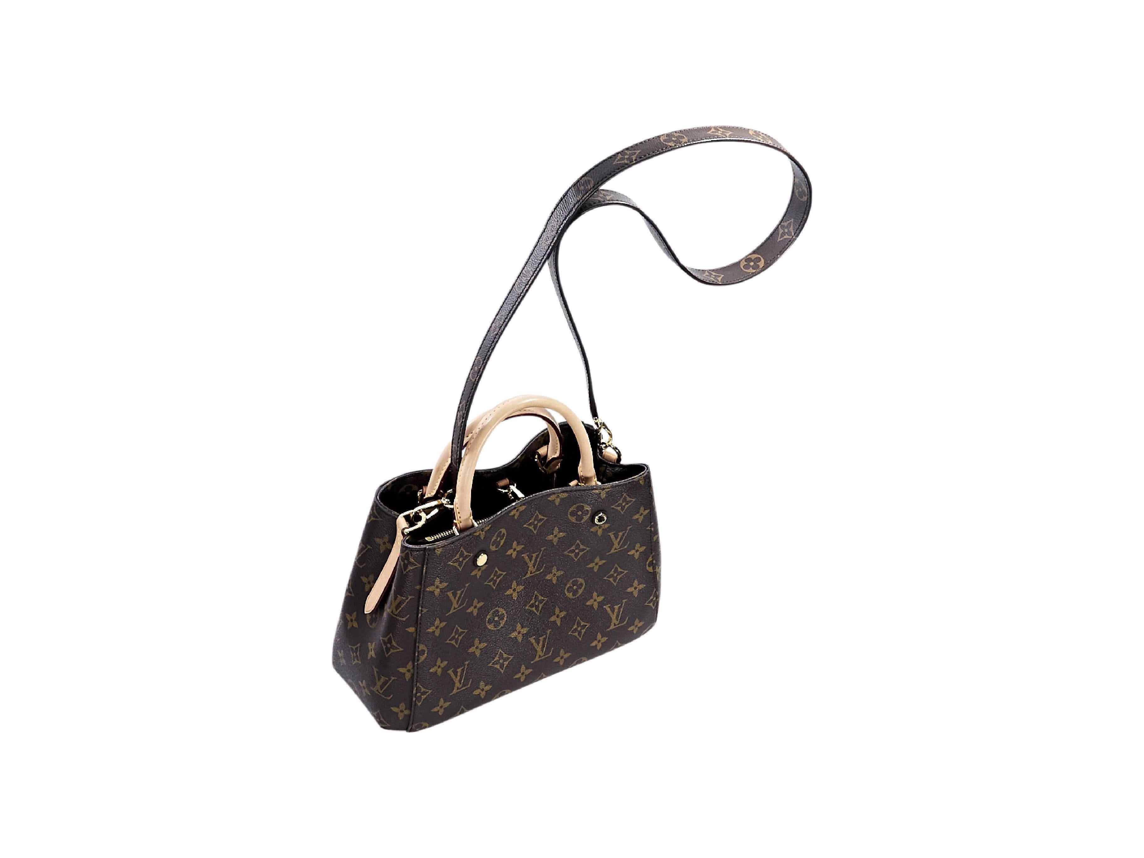 Product details:  Brown monogram canvas Montaigne BB satchel by Louis Vuitton.  Dual carry handle.  Detachable shoulder strap.  Inner bridge clasp closure.  Lined interior with inner center zip compartment and slide pockets.  Protective metal feet. 