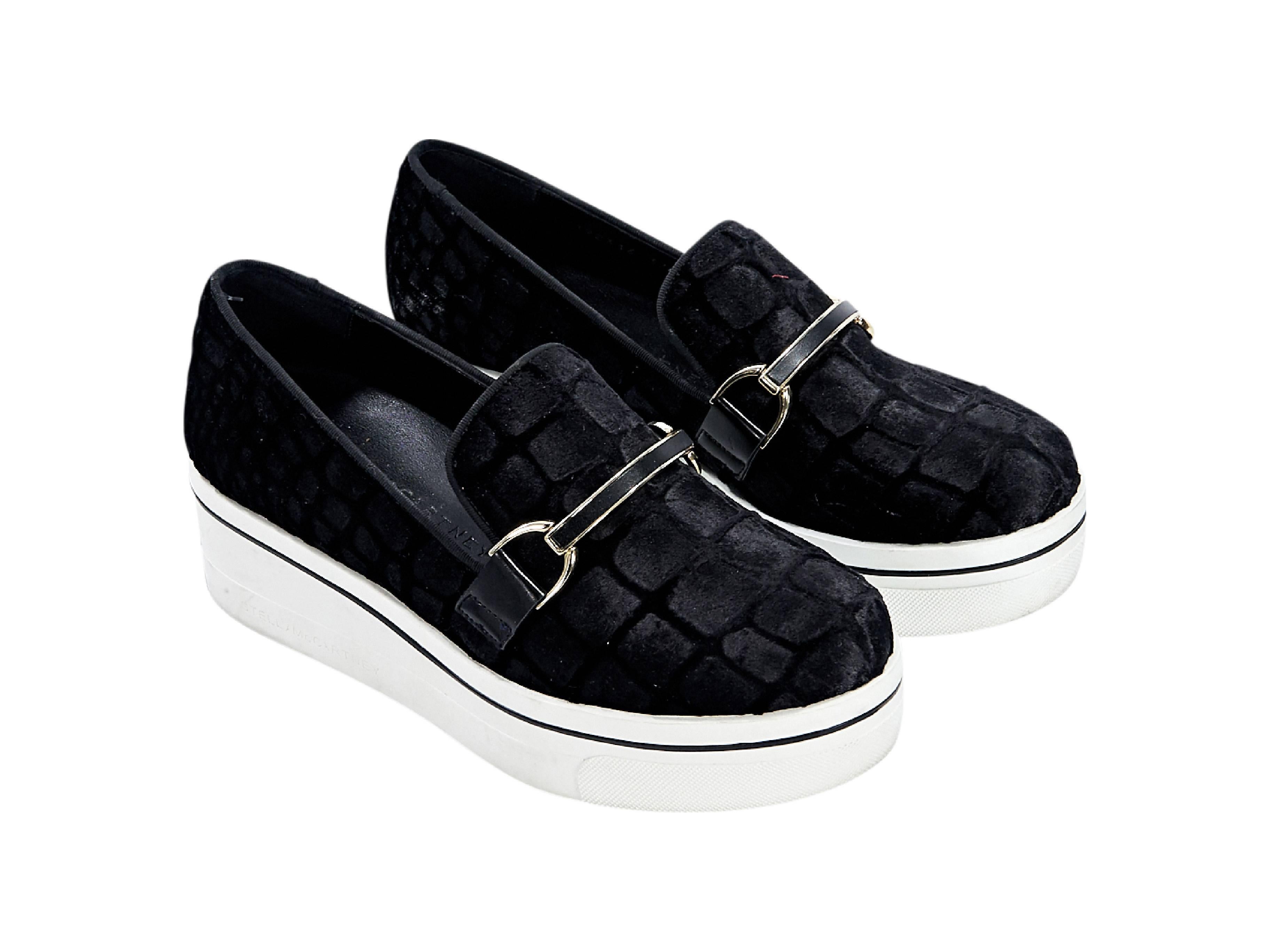 Product details:  Black embossed velvet Binx flatform sneakers by Stella McCartney.  Buckle strap accents vamp.  Round toe.  Slip-on style. Size 7
Condition: Pre-owned. Very good.

Est. Retail $ 595.00