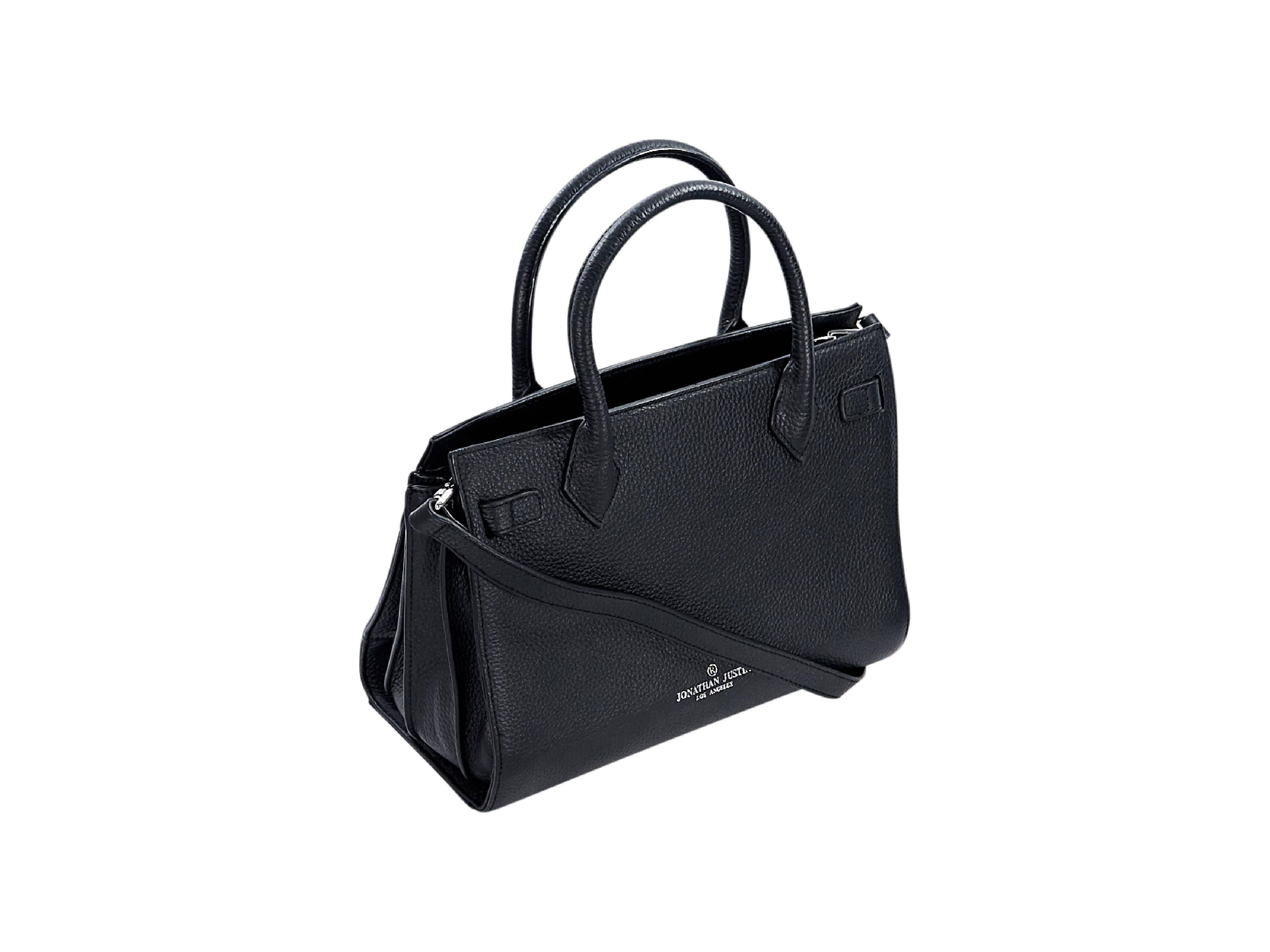 Product details:  Black pebbled leather Elinna Togo satchel by Jonathan Justin.  Dual top carry handles.  Detachable, adjustable crossbody strap.  Open top.  Lined interior with inner zip and slide pockets.  Protective metal feet.  Silvertone