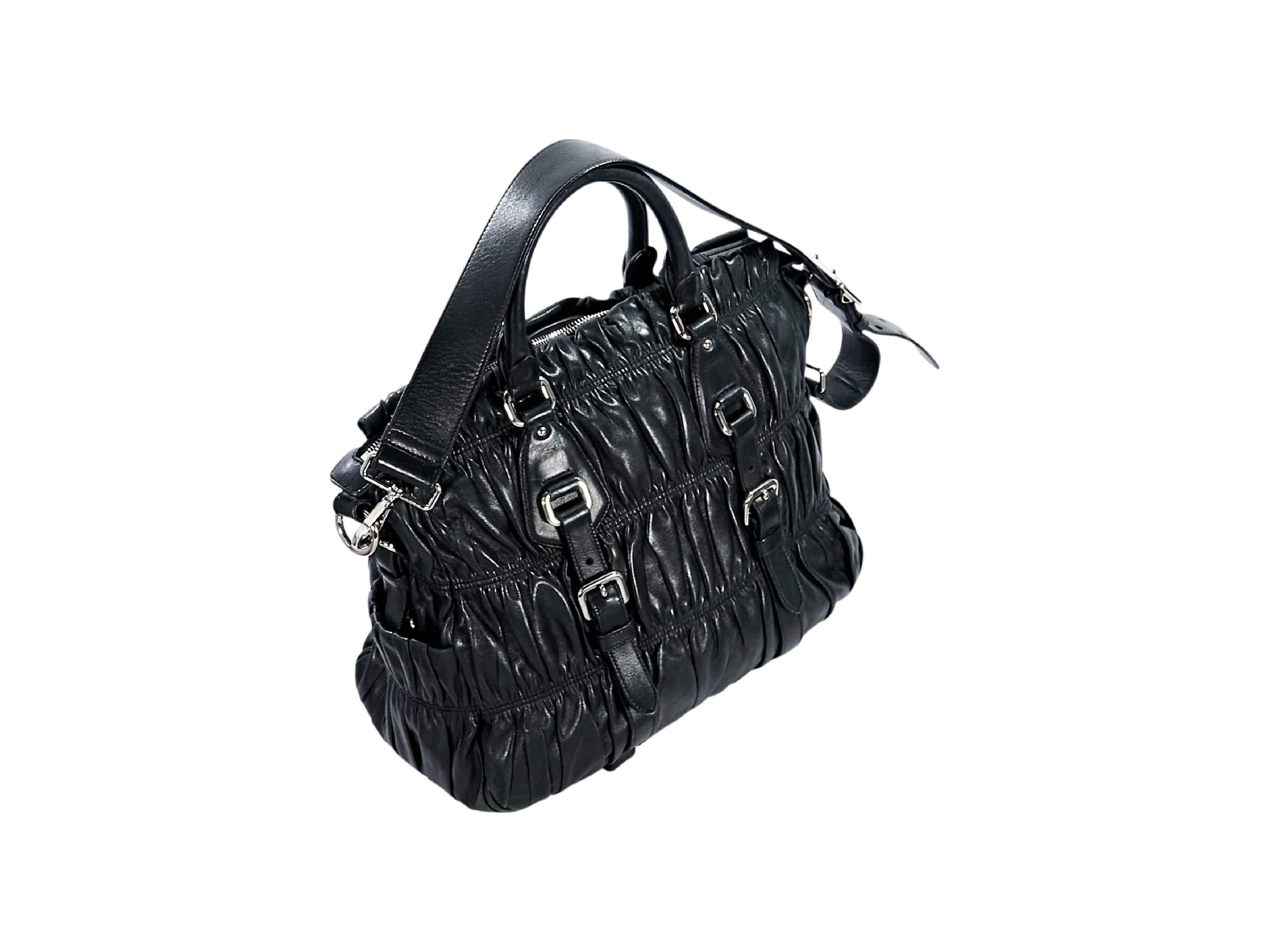 Product details:  Black nappa leather gaufre satchel by Prada.  Dual carry handles.  Detachable, adjustable shoulder strap.  Top zip closure.  Lined interior with inner zip and slide pockets.  Silvertone hardware. 
Condition: Pre-owned. Very