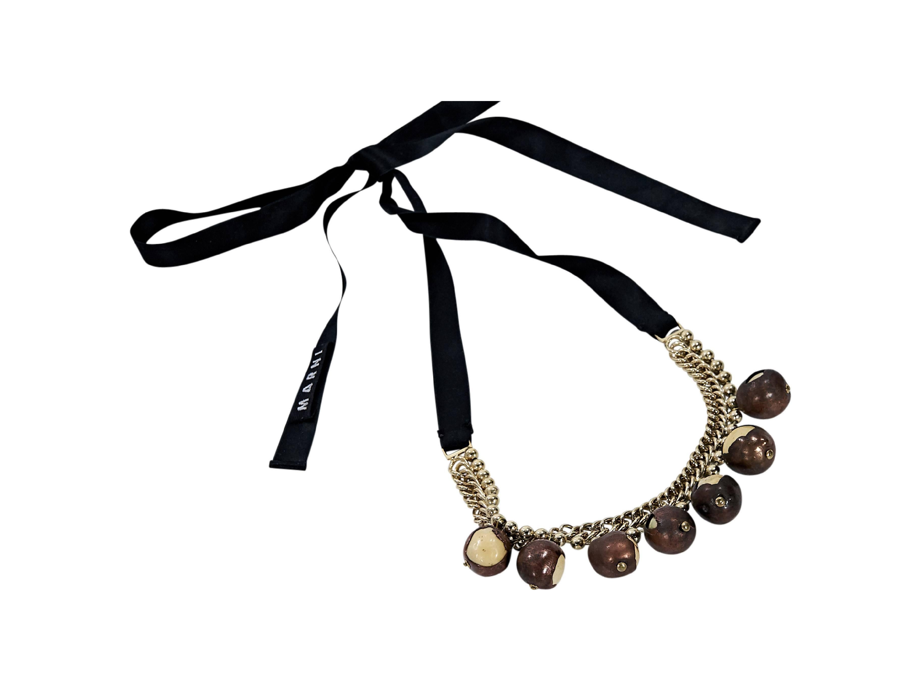 Product details:  Single strand beaded necklace by Marni.  Hanging brown resin beads.  Adjustable self-tie closure.  Goldtone hardware. 
Condition: Pre-owned. Very good.

Est. Retail $ 675.00