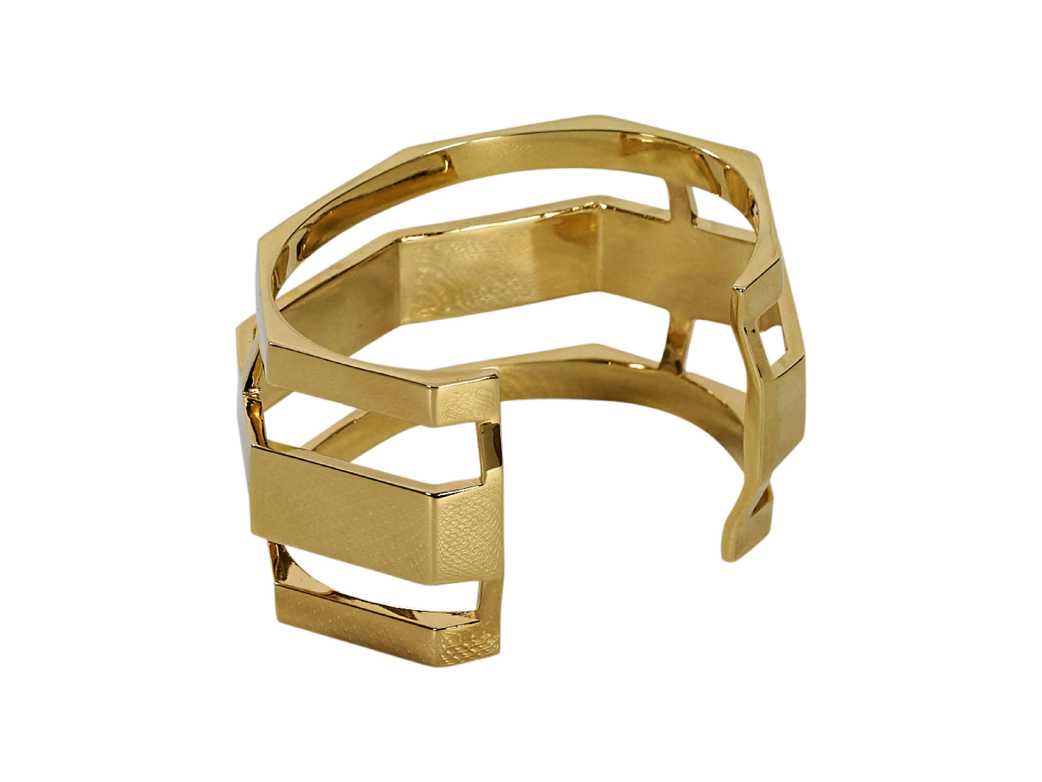 Product details:  Wide goldtone cuff by Via Saviene.  
Condition: Pre-owned. Very good.

Est. Retail $ 225.00