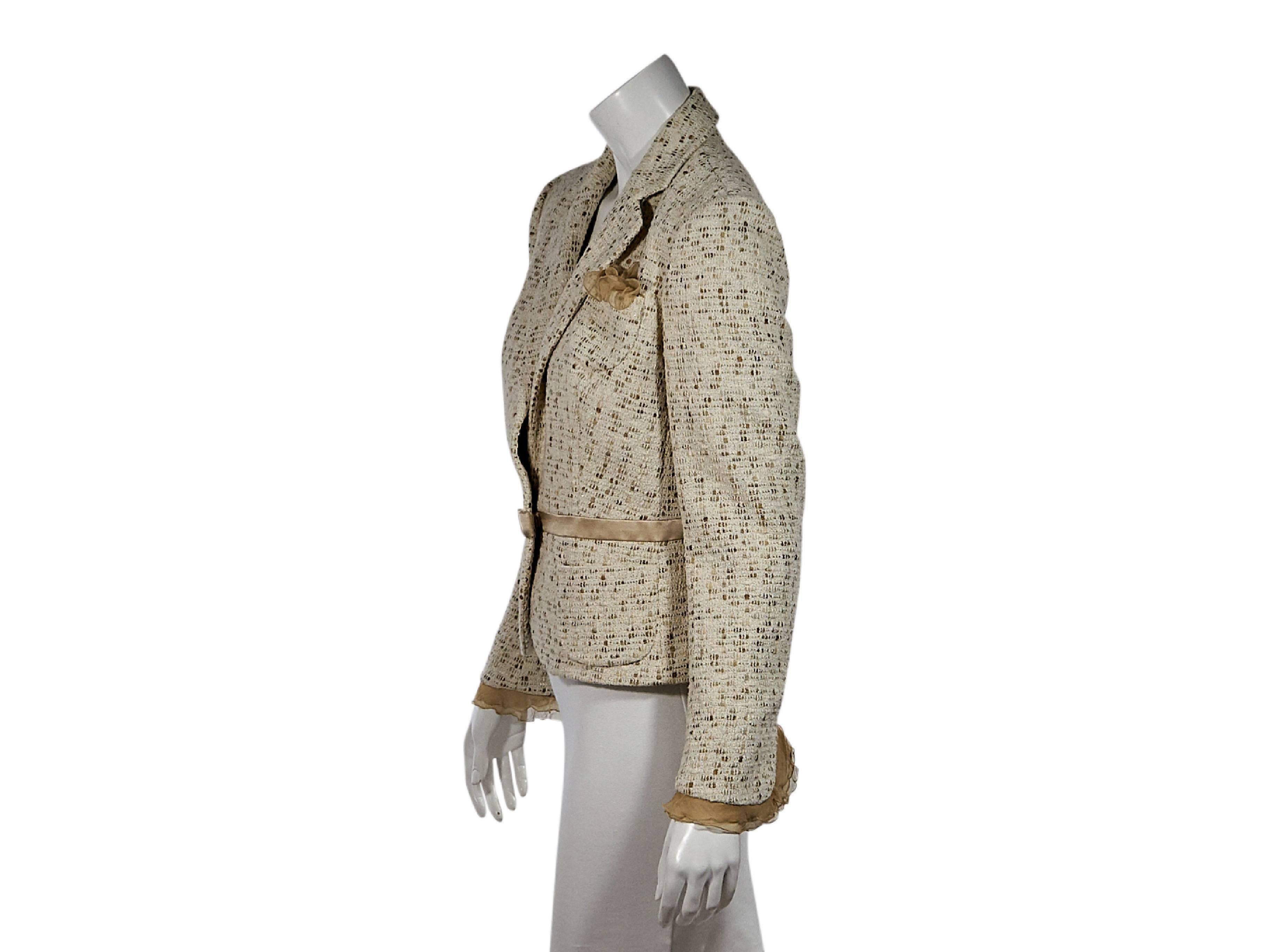 Product details:  Cream woven blazer by Salvatore Ferragamo.  Notched lapel.  Long sleeves.  Chiffon-trimmed cuffs.  Concealed button-front closure.  Chest and waist patch pockets.  Waist trimmed with satin and a satin bow. Size 8
Condition: