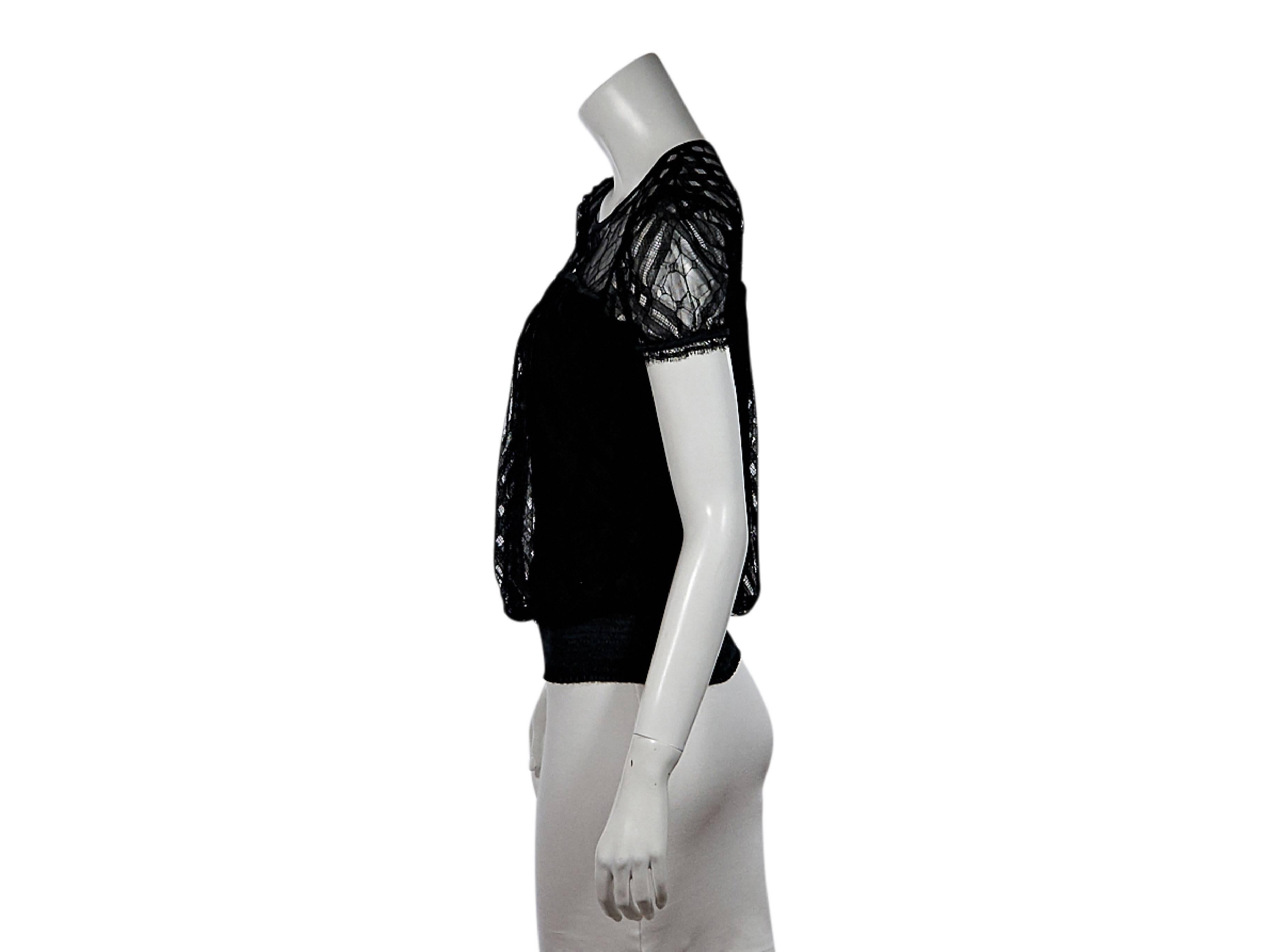 Product details:  Black lace blouse by Chanel.  Jewelneck.  Short sleeves.  Wide hem.  Pullover style.  Size 4
Condition: Pre-owned. Very good.

Est. Retail $ 995.00