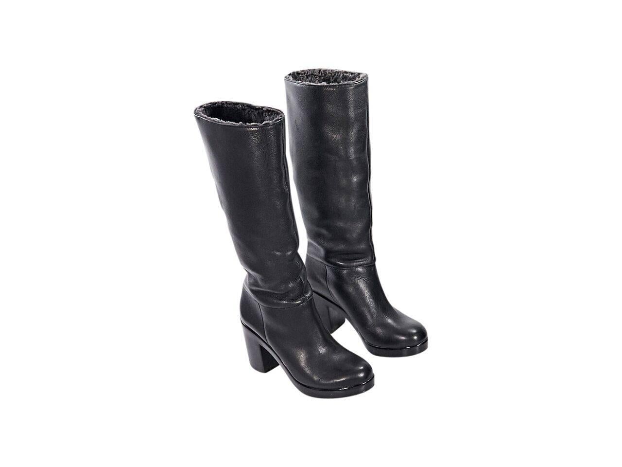 Product details:  Black leather tall boots by Robert Clergerie.  Round toe.  Chunky block heel and platform.  Fuzzy lining.  Pull-on style.  
Condition: Pre-owned. Very good.
Est. Retail $ 995.00