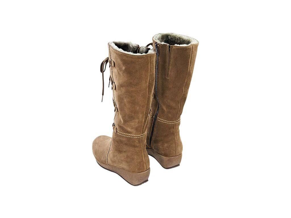 Product details:  Tan suede tall winter boots by La Canadienne.  Lace-up front panel.  Inner zip closure.  Round toe.  Low wedge design.  
Condition: Pre-owned. Very good.
Est. Retail $ 528.00