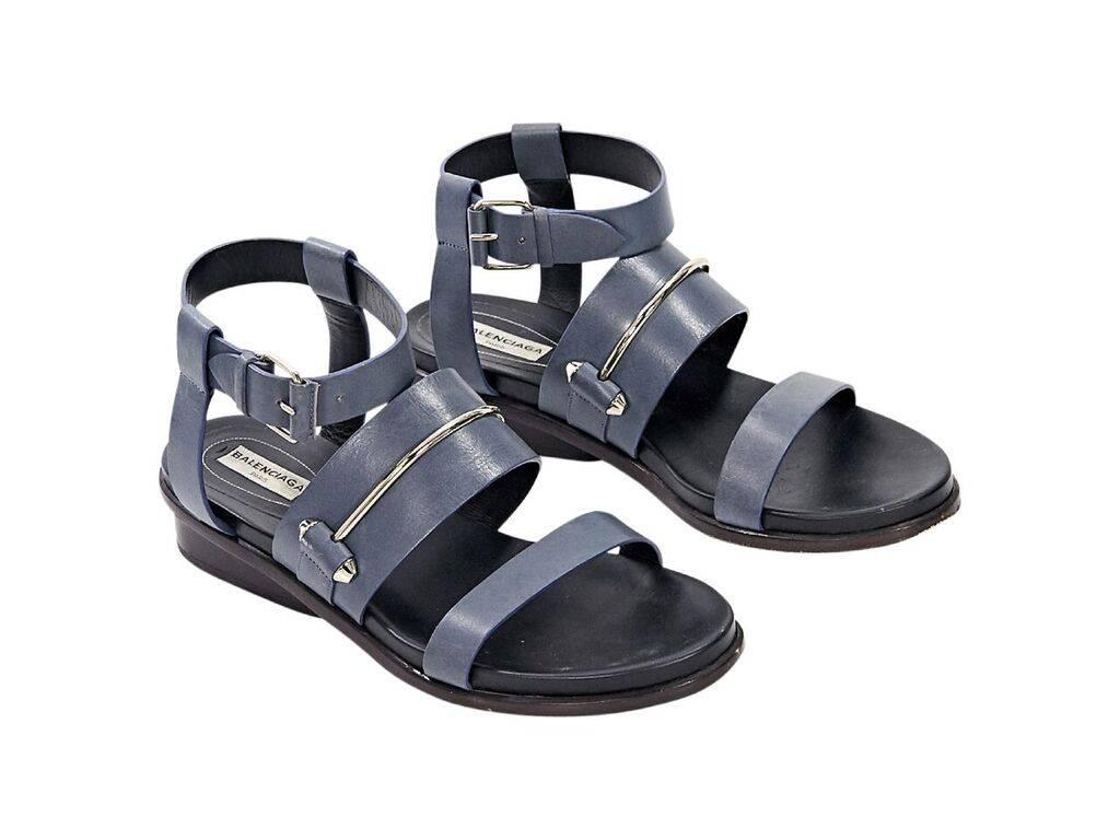 Product details:  Blue leather strappy sandals by Balenciaga.  Adjustable ankle strap.  Open toe.  Low stacked heel.  Silvertone hardware. 
Condition: Pre-owned. Very good.
Est. Retail $ 625.00