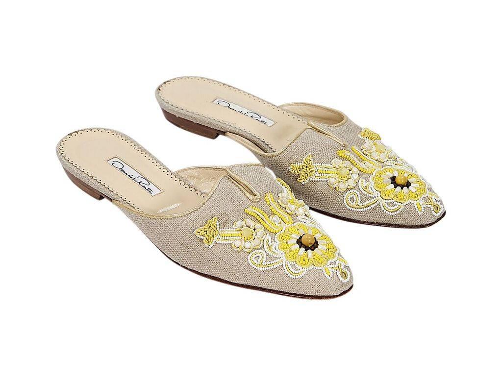Product details:  Beige woven flat mules by Oscar de la Renta.  Beaded embellished vamp.  Slide-on style.  
Condition: Pre-owned. Very good.
Est. Retail $ 798.00