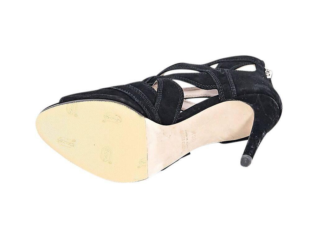 Product details:  Black suede cutout sandals by Miu Miu.  Accented with topstitching.  Back zip closure.  Peep toe.  
Condition: Pre-owned. Very good.
Est. Retail $ 398.00