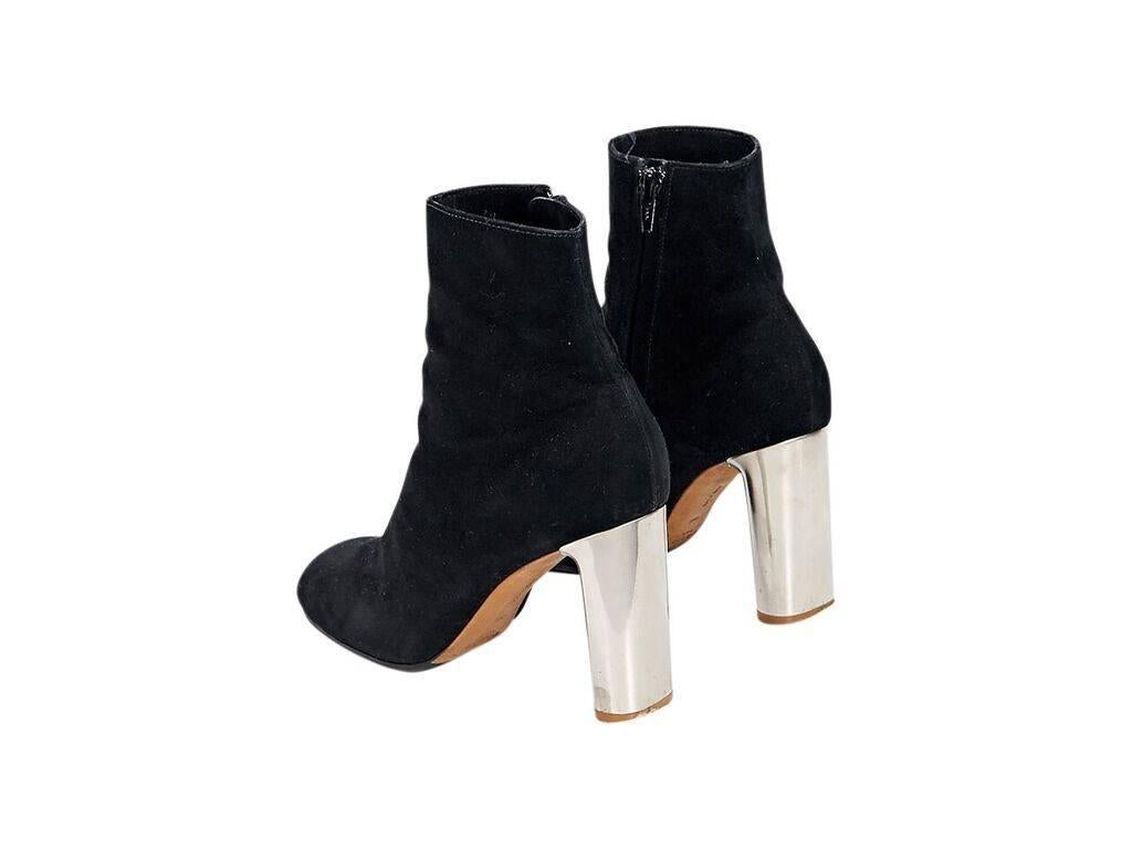 Product details:  Black suede ankle boots by Céline.  Inner zip closure.  Round toe.  Metallic silvertone heel. 
Condition: Pre-owned. Very good.
Est. Retail $ 1,086.00