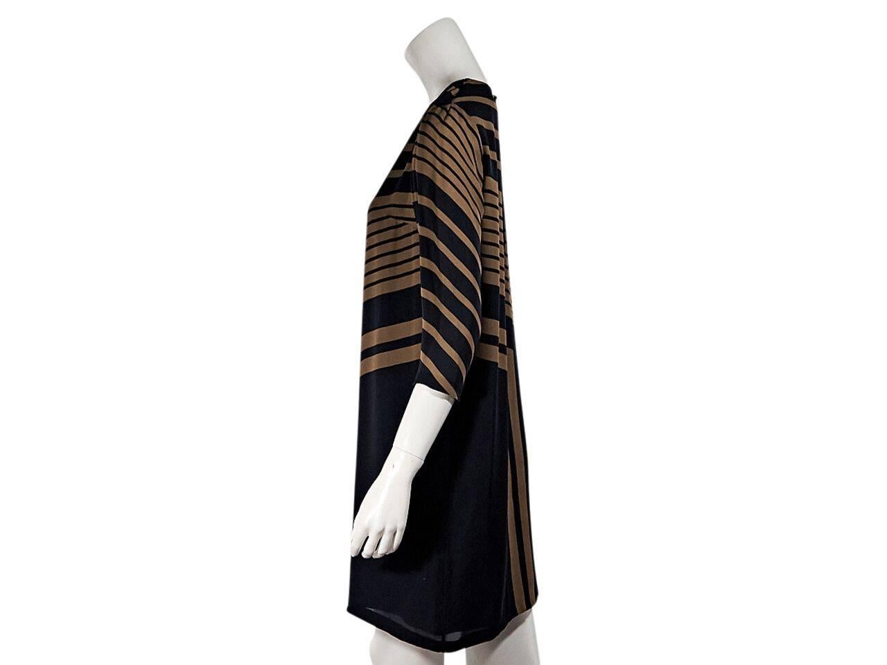 Product details:  Brown and navy blue geometric striped silk shift dress by Stella McCartney.  Roundneck.  Three-quarter length sleeves.  Back button closure with keyhole cutout. 
Condition: Pre-owned. Very good.
Est. Retail $ 698.00