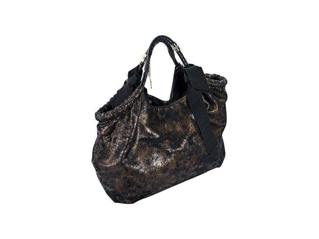 Product details:  Black and copper hobo bag by Stella McCartney.  Dual shoulder straps.  Magnetic snap closure.  Lined interior with inner zip pocket.  Goldtone hardware.  16