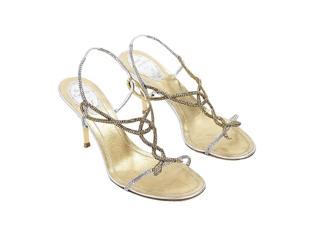 Product details:  Metallic silver and gold embellished evening sandals by René Caovilla.  Slingback strap with inset elastic panel.  Open toe. 
Condition: Pre-owned. Very good.
Est. Retail $ 698.00