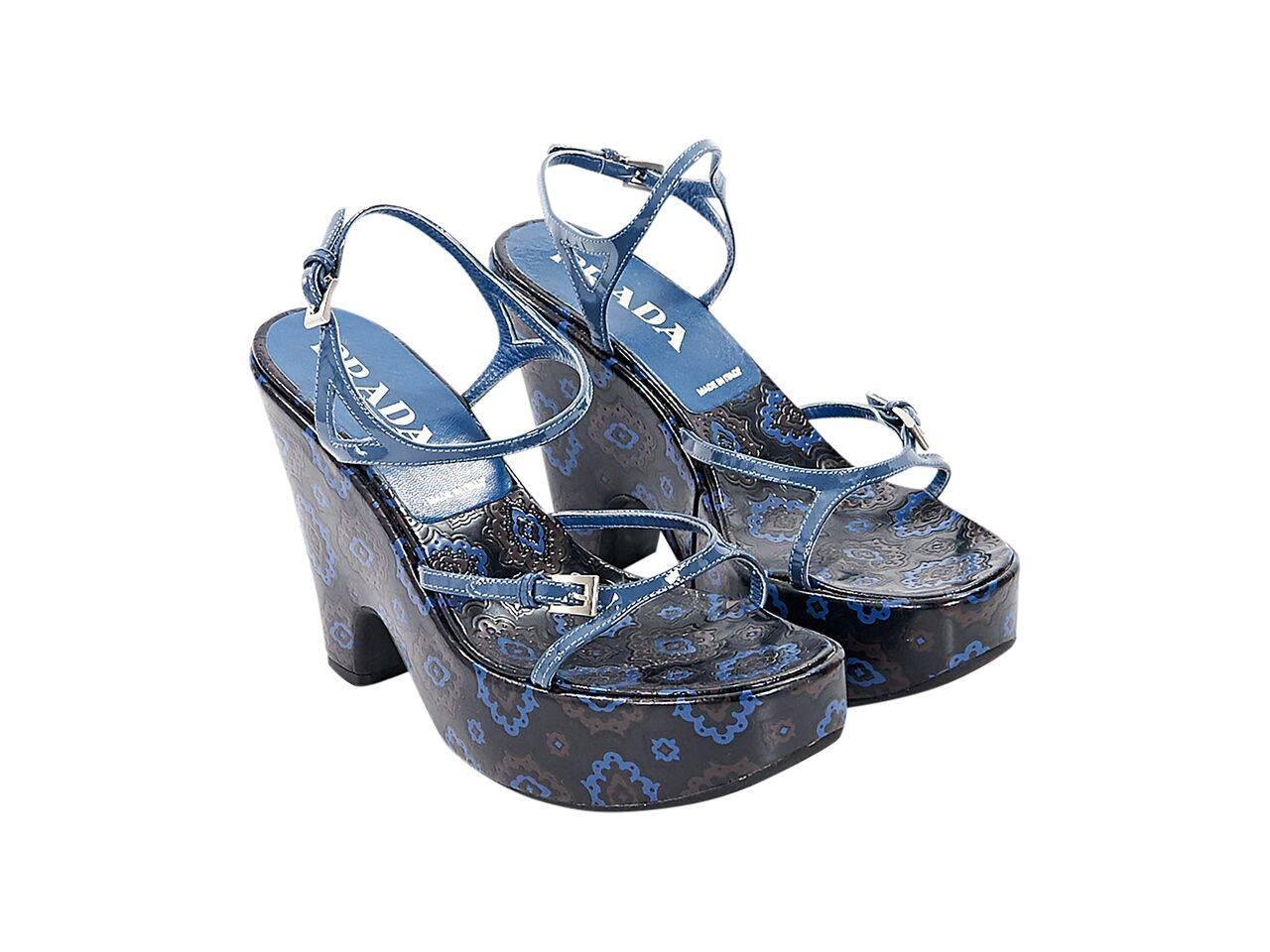 Product details:  Blue and brown patterned leather wedge sandals by Prada.  Adjustable slingback strap.  Open toe.  Silvetone hardware. 
Condition: Pre-owned. Very good.
Est. Retail $ 498.00