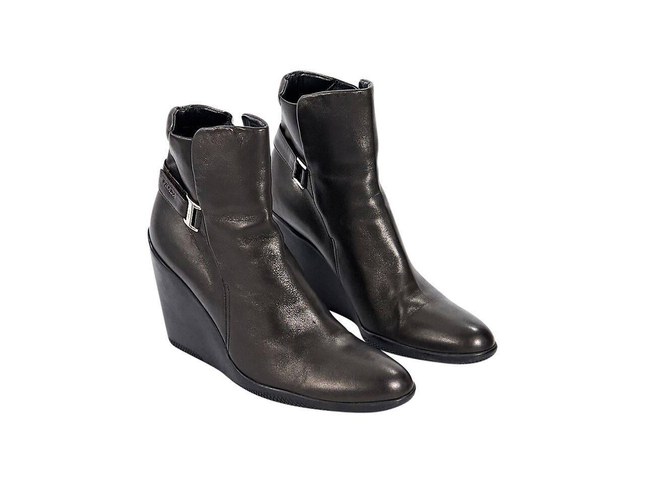 Product details:  Brown leather wedge ankle boots by Prada Sport.  Velcro strap closure.  Round toe.  
Condition: Pre-owned. Very good.
Est. Retail $ 525.00