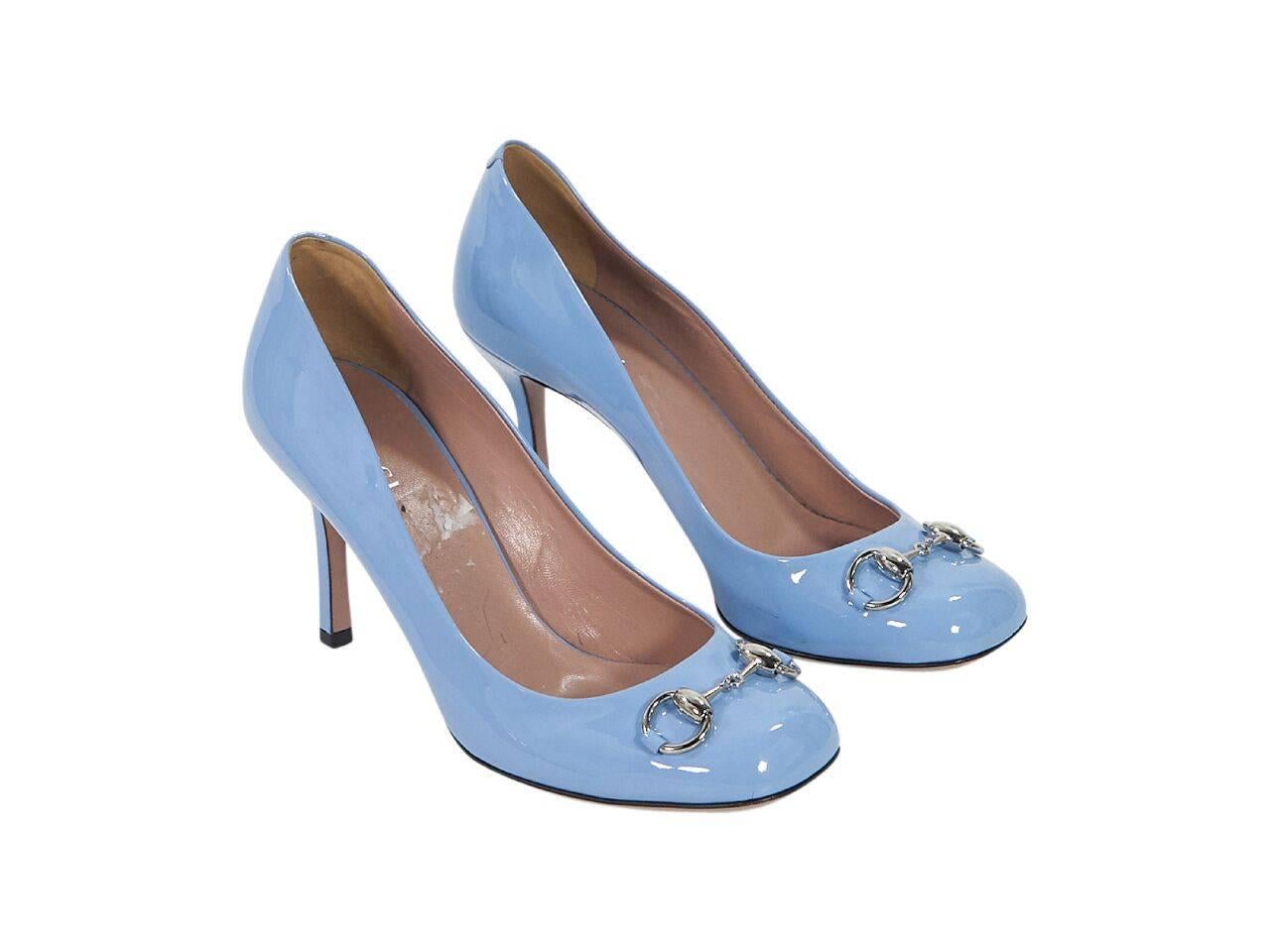 Product details:  Periwinkle patent leather pumps by Gucci.  Signature horsebit detail accents vamp.  Round toe.  Slip-on style.  Silvertone hardware. 
Condition: Pre-owned. Very good.
Est. Retail $ 598.00