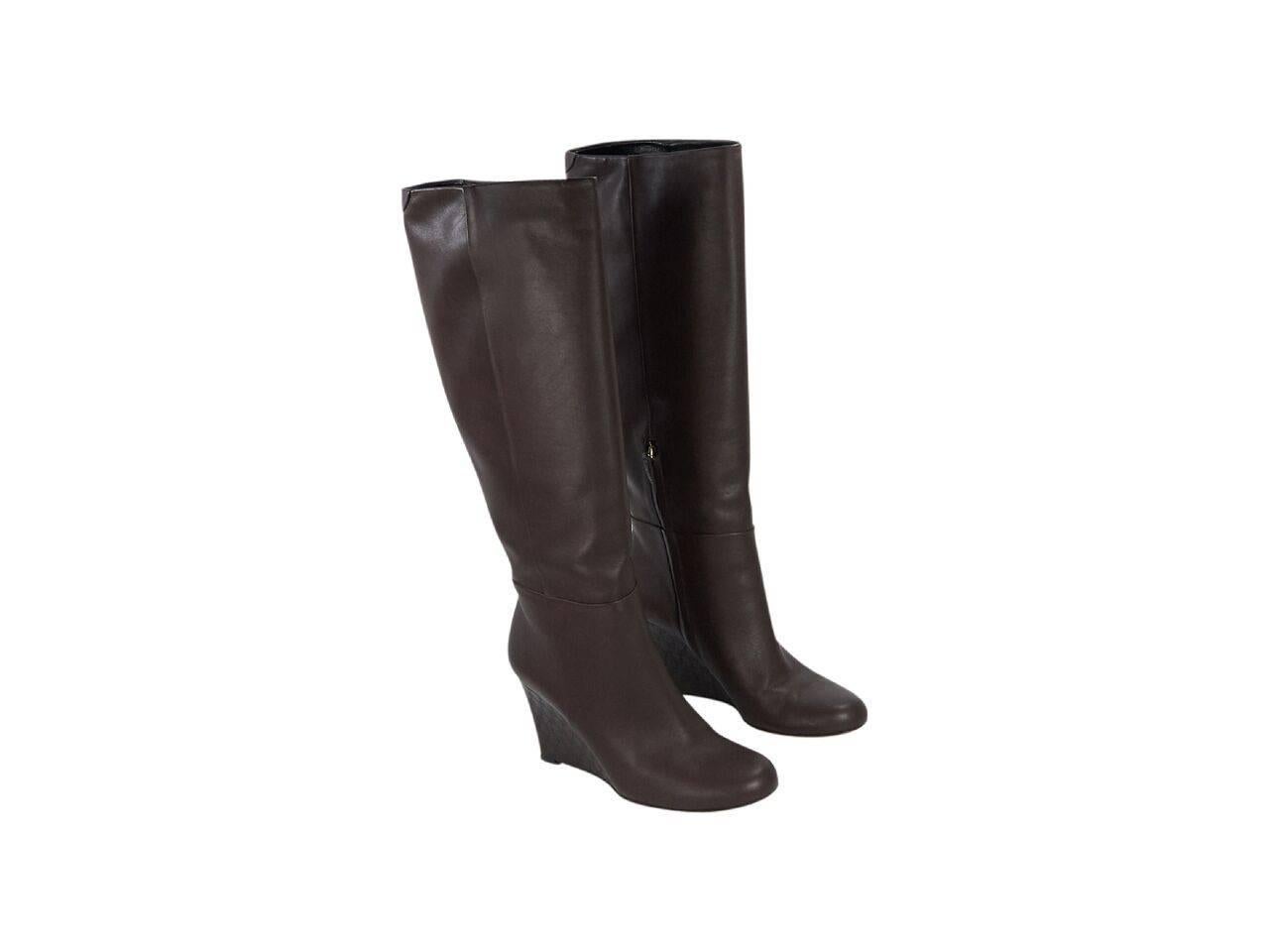 Product details:  Brown leather tall wedge boots by Gucci.  Inner half zip closure.  Guccissima embossed wedge.  Round toe. 
Condition: Pre-owned. Very good.
Est. Retail $ 1,298.00