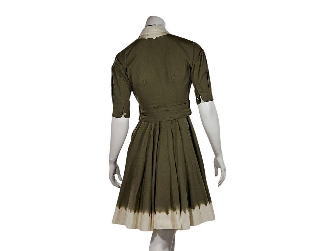 Product details:  Green pleated fit-and-flare dress by Prada.  Spread collar.  Elbow-length sleeves.  Single button cuff.  Concealed button front and side zip closure.  Pleated banded waist.  Flared skirting with a dip-dyed hem. 
Condition: