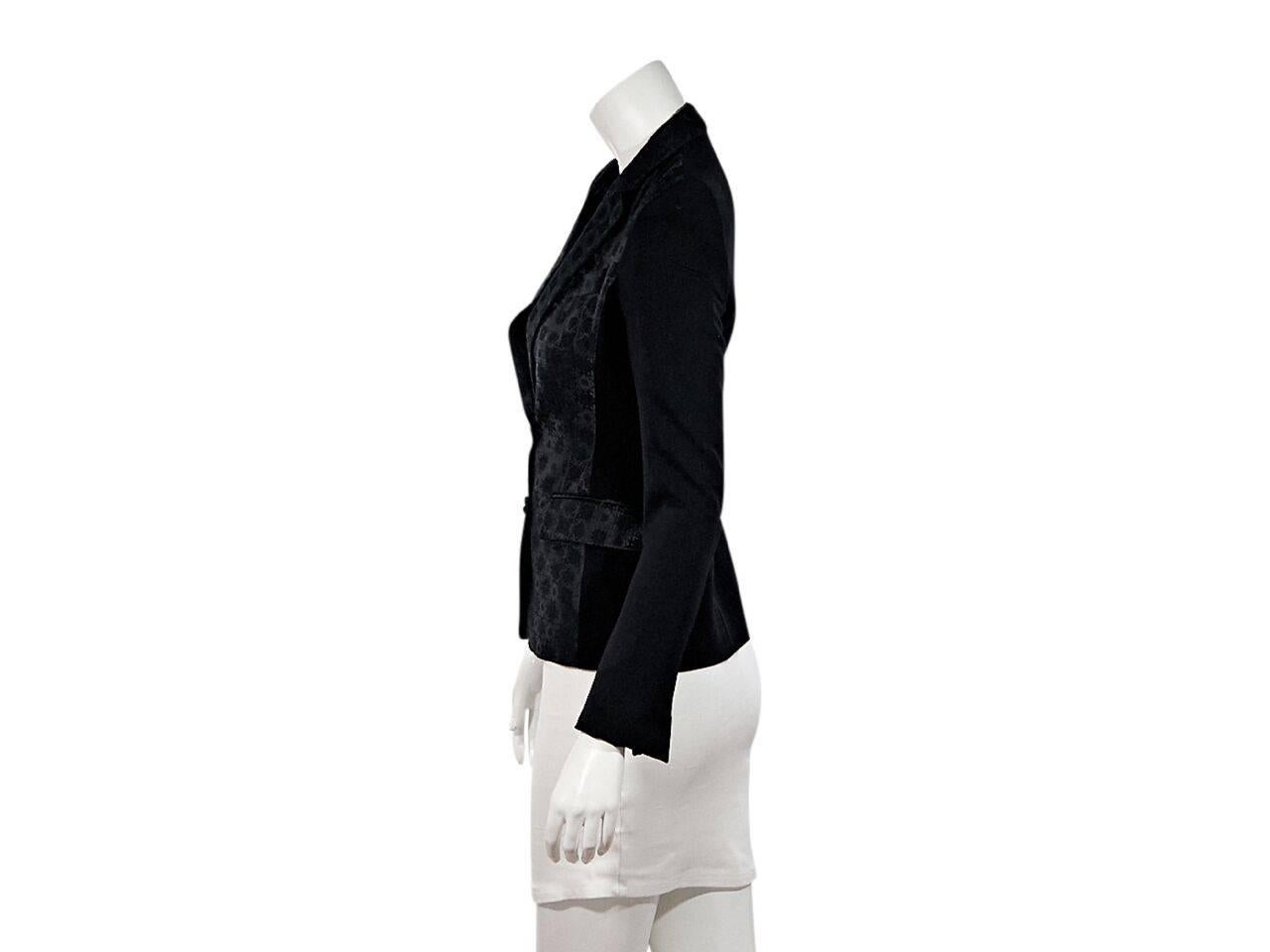 Product details:  Black jacquard-front blazer by Stella McCartney.  Notched lapel.  Long sleeves.  Button-front closure.  
Condition: Pre-owned. Very good.
Est. Retail $ 798.00