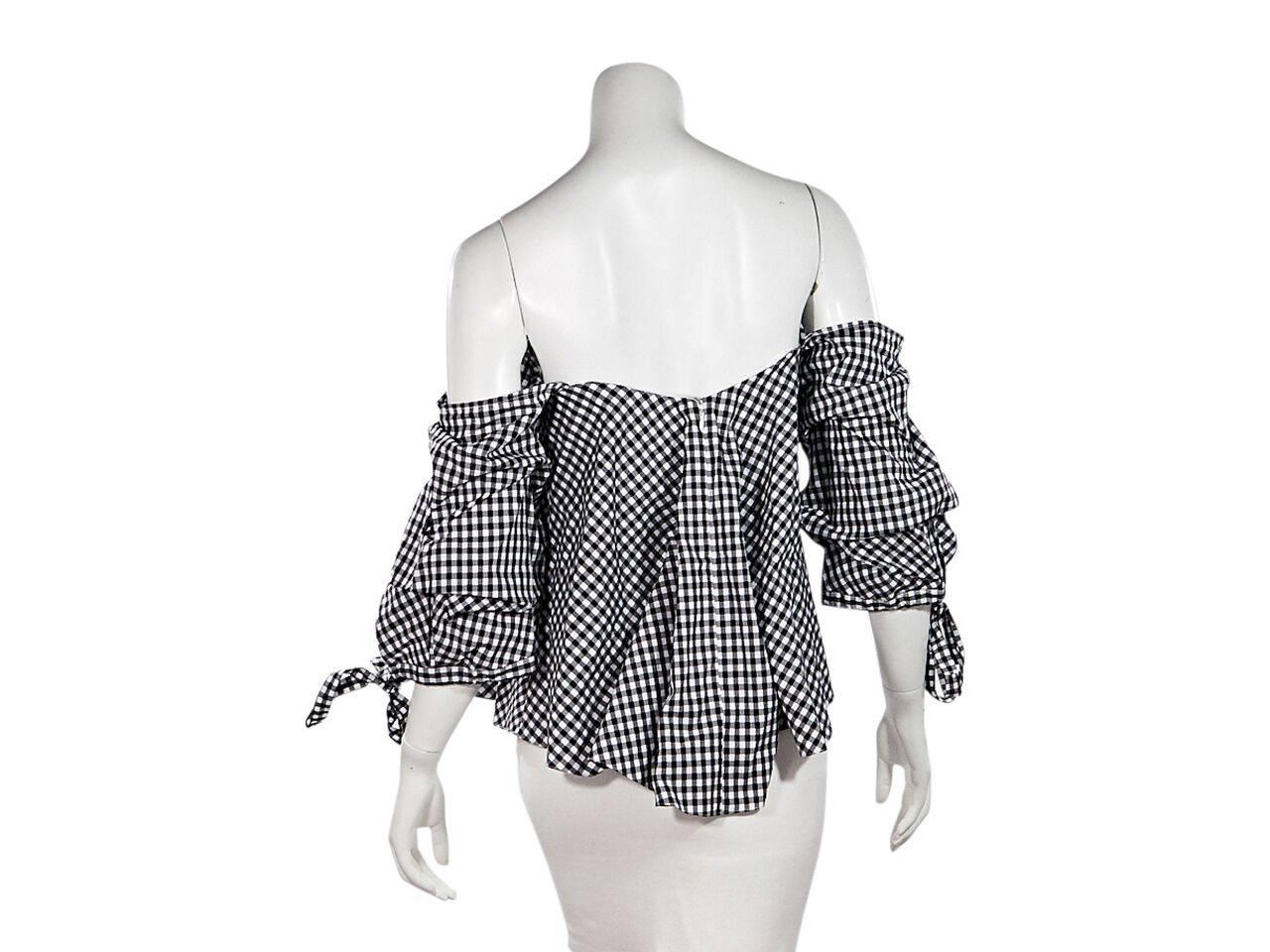 Product details:  Black and white gingham cotton off-the-shoulder top by Caroline Constas.  Sweetheart neckline.  Three-quarter length sleeves.  Tie cuffs.  Inner lining with boning.  Concealed back zip closure. 
Condition: Pre-owned. Very