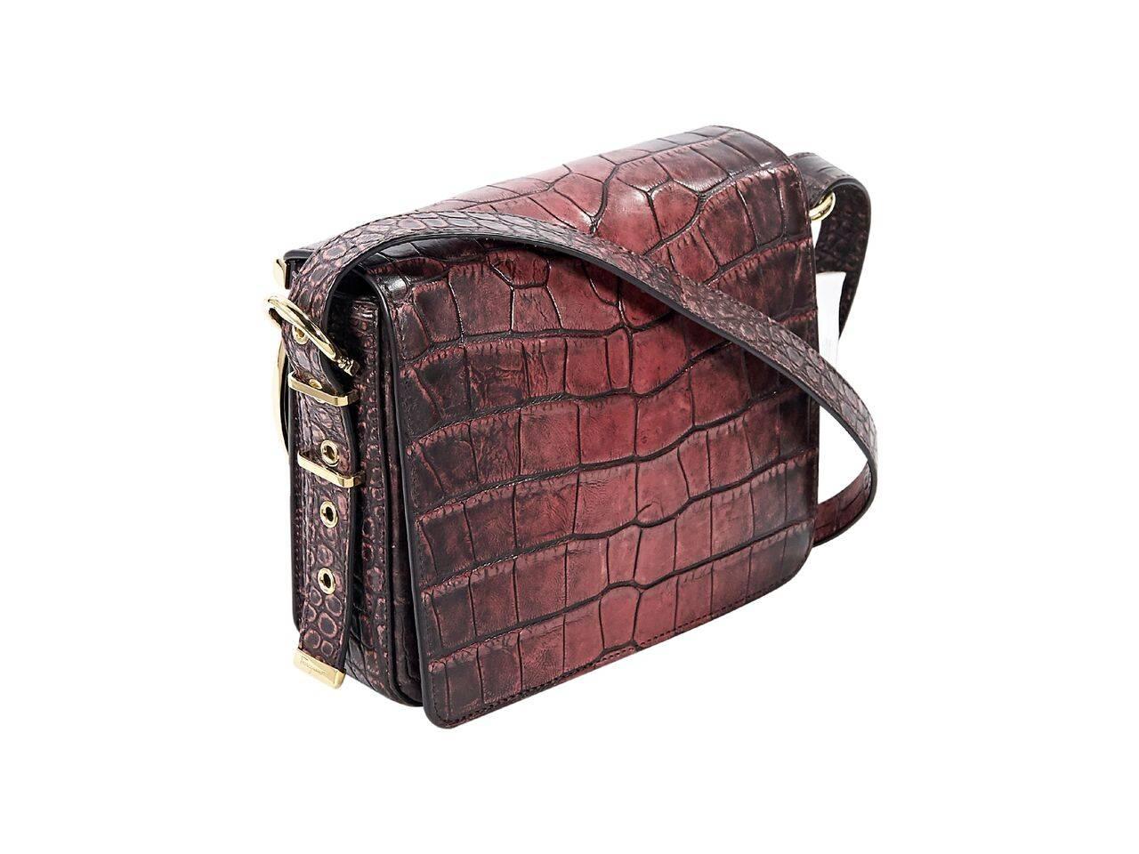Product details:  Red alligator crossbody bag by Salvatore Ferragamo.  Adjustable crossbody strap.  Front flap with logo hardware detail.  Concealed magnetic closure.  Leather interior with inner zip pocket.  Goldtone hardware.  7.5