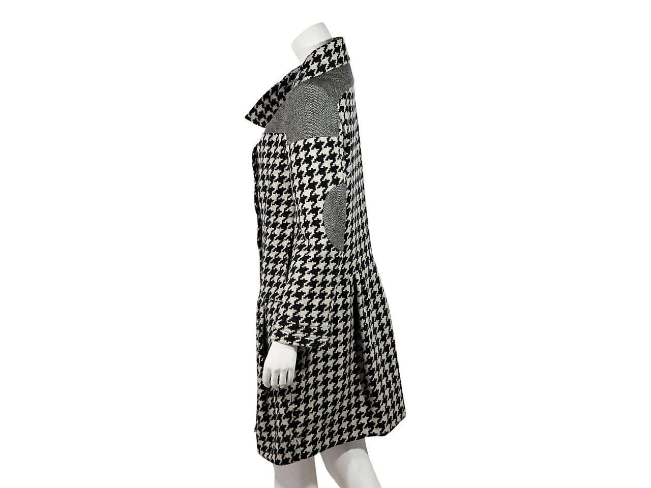 Product details:  Black and white houndstooth coat by Stella McCartney.  Shawl collar.  Long sleeves with elbow patches.  Button-front closure.  Label size IT 44. 
Condition: Pre-owned. Very good.
Est. Retail $ 2,525.00